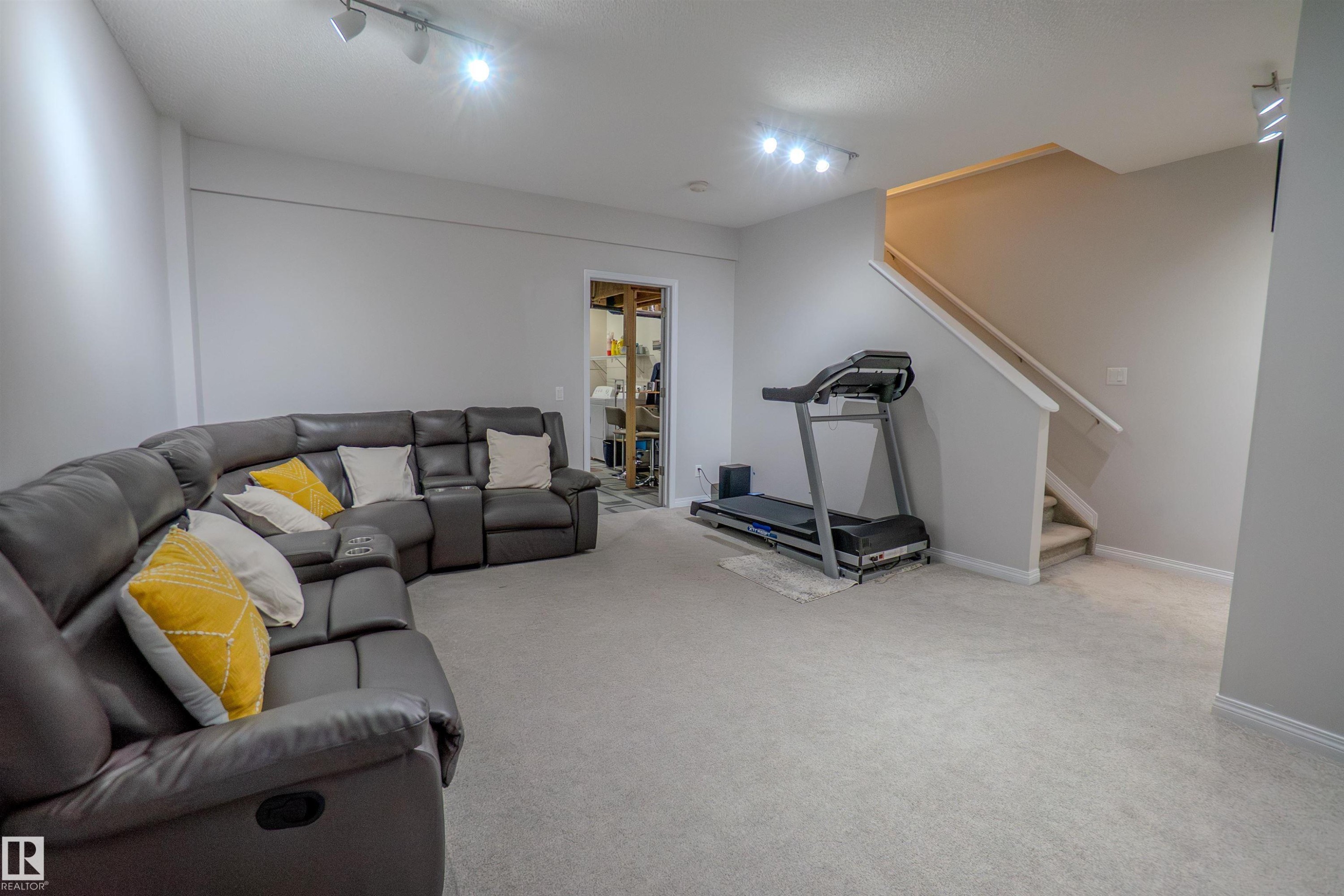 Spacious lower-level area with light-toned carpet flooring and neutral wall tones - 1766 Dumont Crescent Sw, Edmonton, AB - Indoor