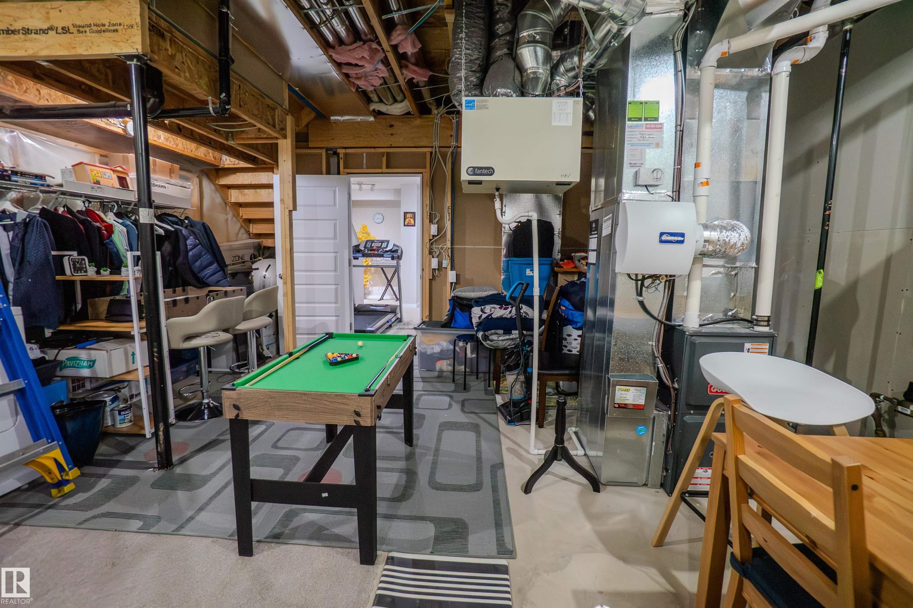 Basement utility area featuring exposed wood joists and ductwork, a furnace system, and an additional air handling unit - 1766 Dumont Crescent Sw, Edmonton, AB - Indoor Photo Showing Basement