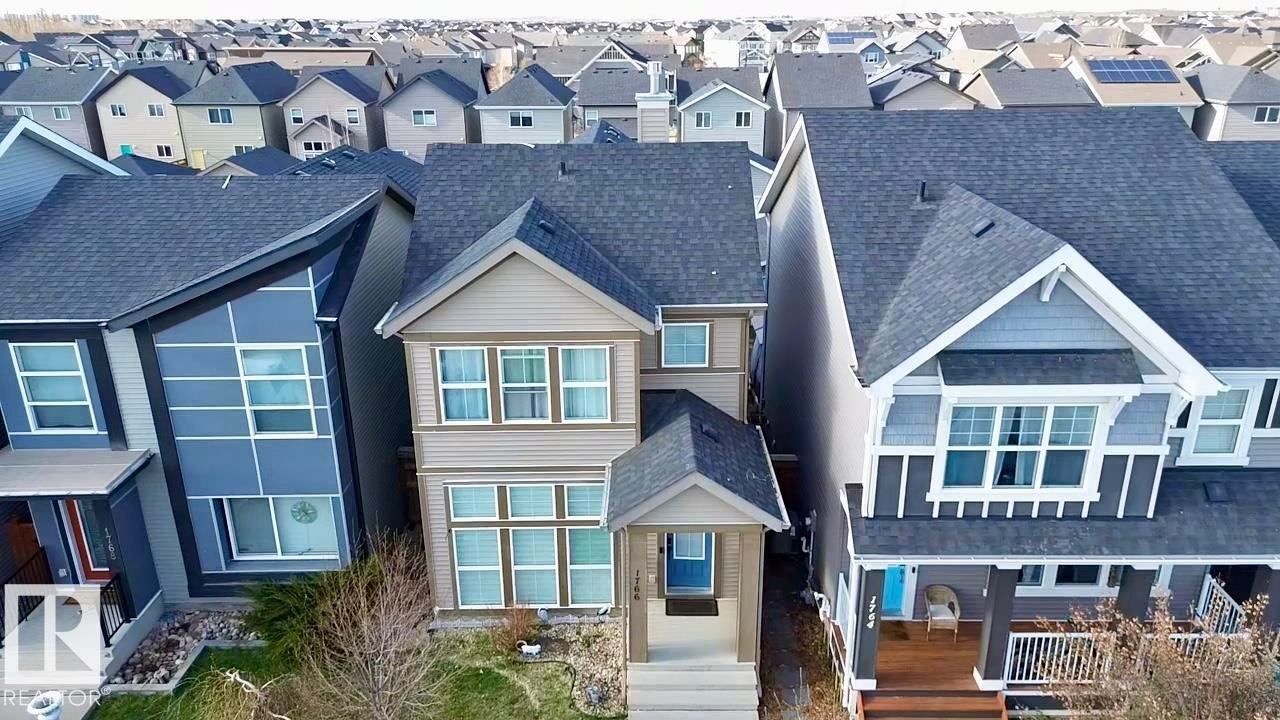 Two-story residence featuring a neutral-toned facade with multiple windows - 1766 Dumont Crescent Sw, Edmonton, AB - Outdoor With Facade