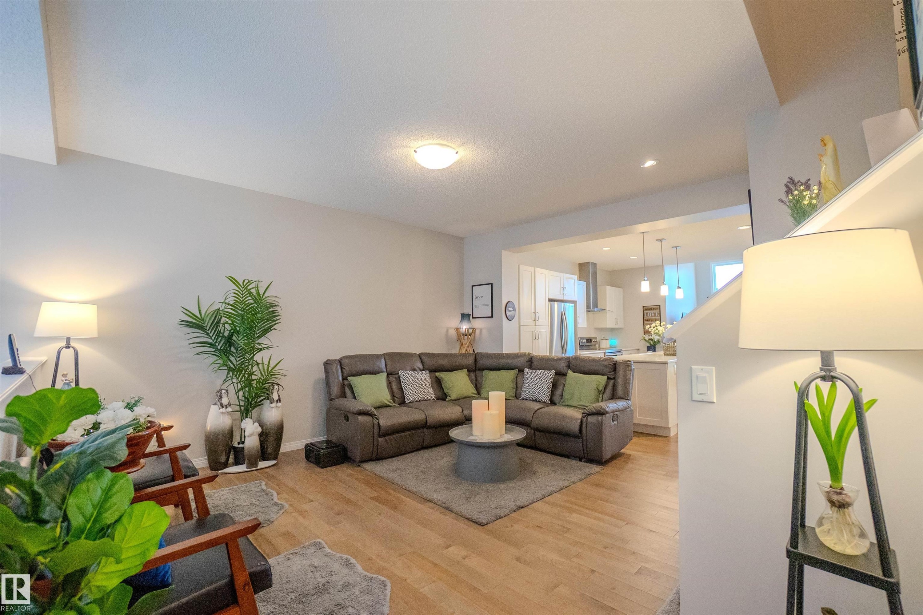 Open-concept living space featuring wood-finish flooring, recessed lighting, and a neutral color palette - 1766 Dumont Crescent Sw, Edmonton, AB - Indoor