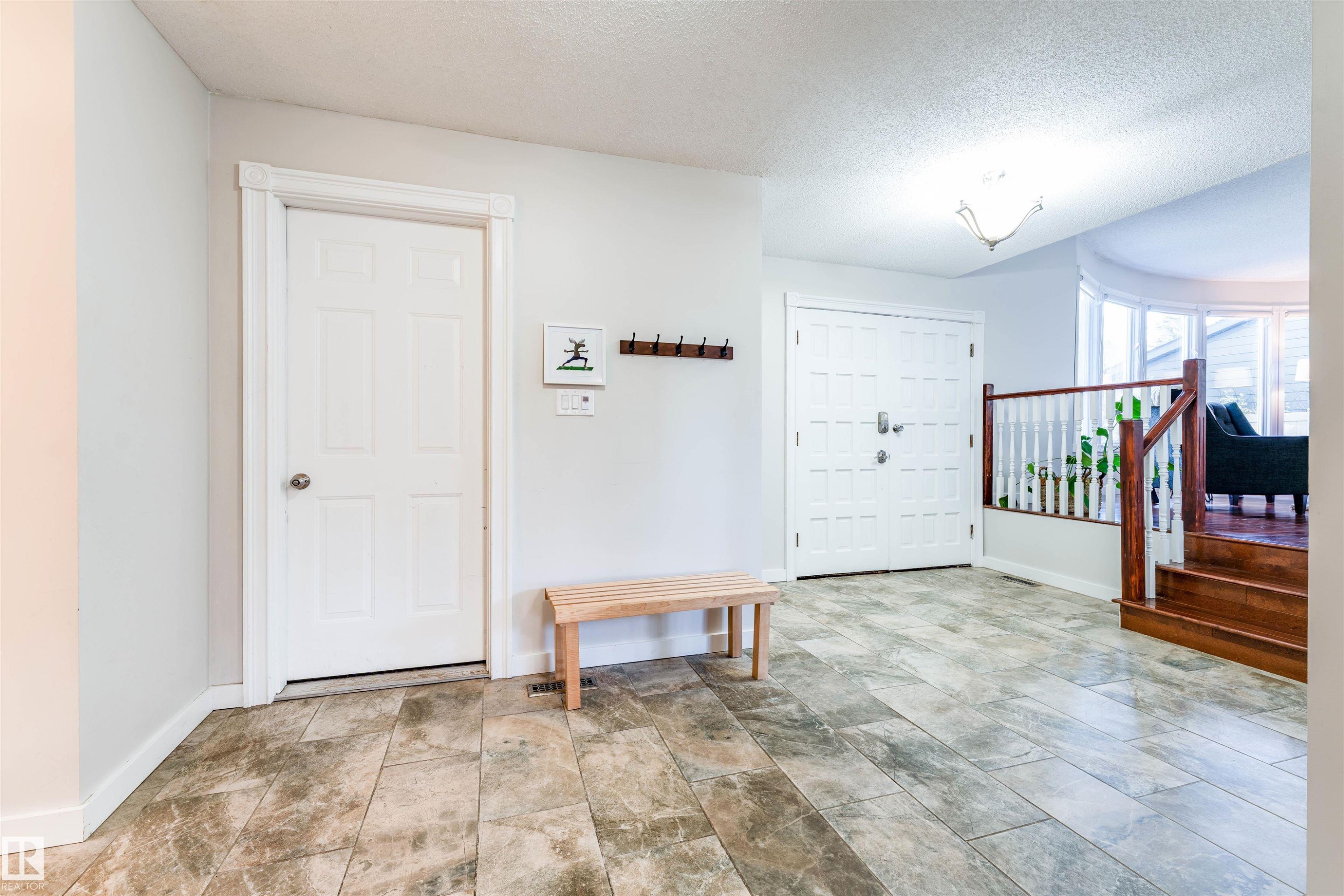 Large entryway featuring tile flooring and double entrance doors. - 5212 142 Street Nw, Edmonton, AB