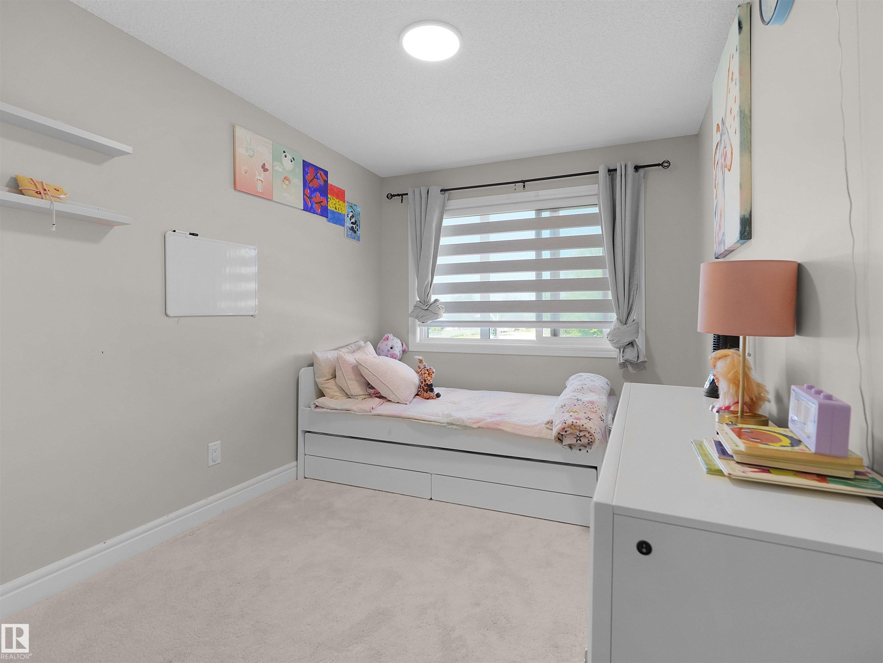Light-colored wall paint and carpet flooring enhance the bright ambiance of this room - #30 4137 76 St Nw, Edmonton, AB