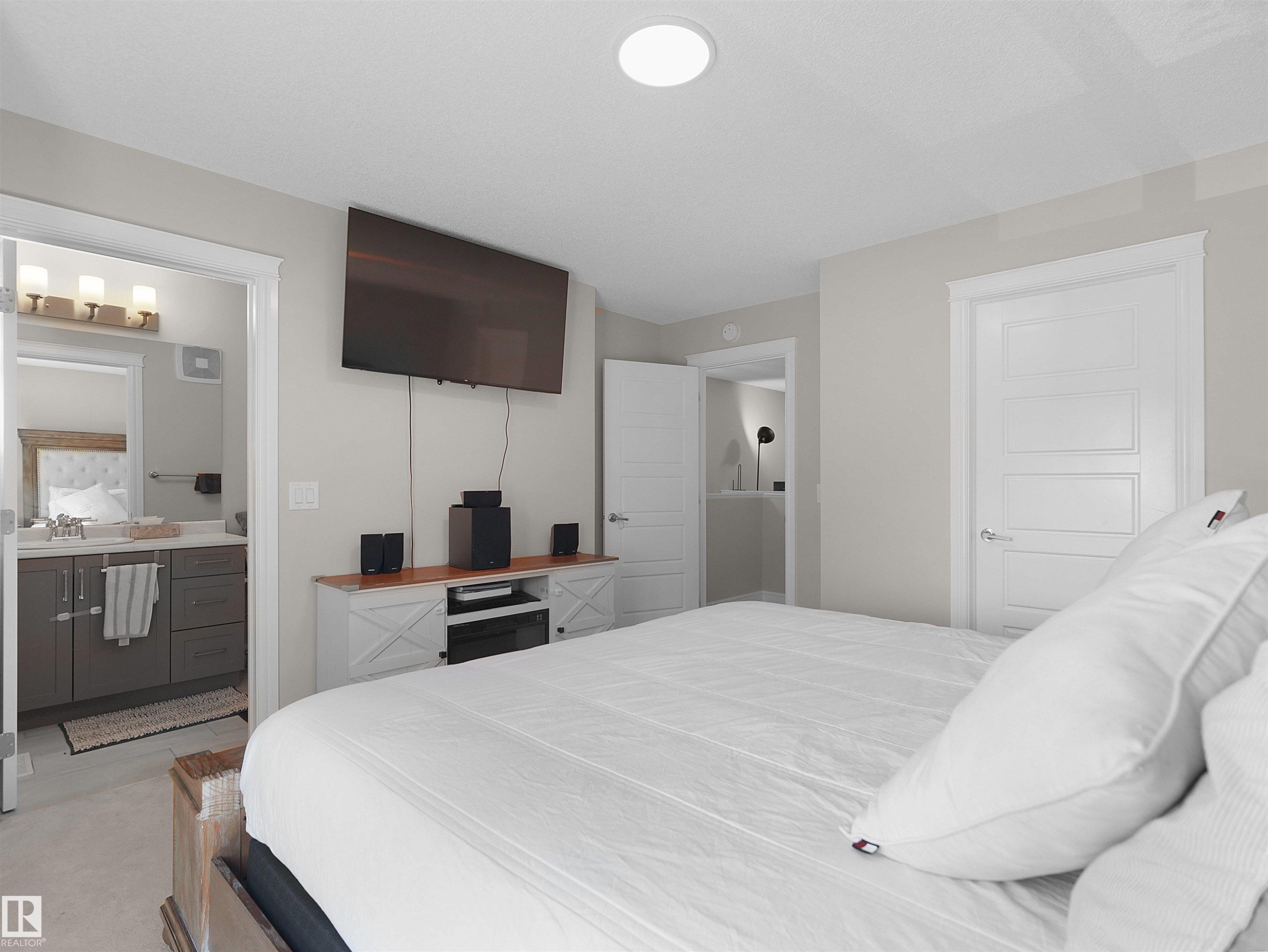 Light-toned walls complement a contemporary ceiling-mounted light fixture - #30 4137 76 St Nw, Edmonton, AB