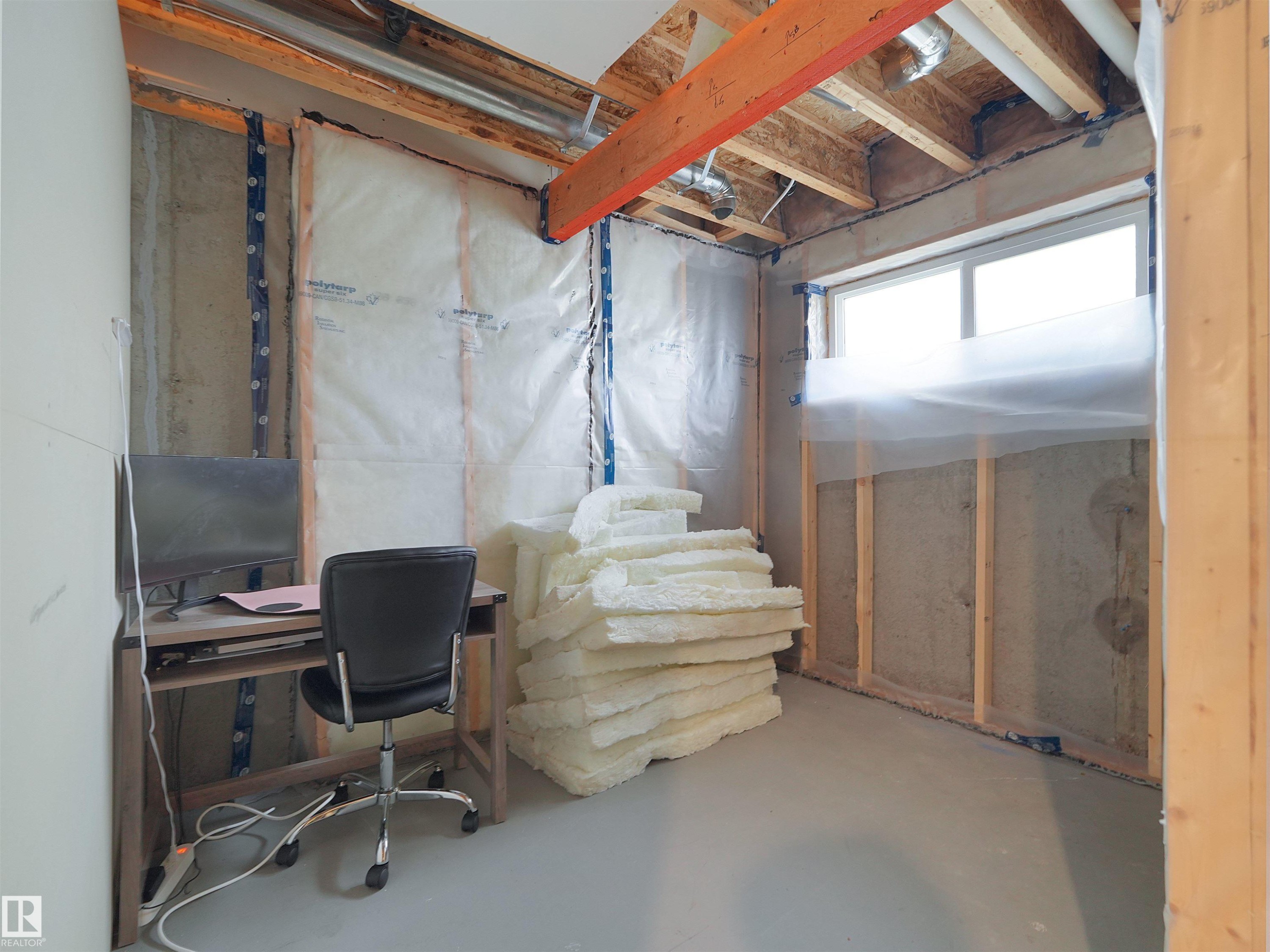 Unfinished basement space featuring exposed wood framing, a concrete foundation, and a concrete floor - #30 4137 76 St Nw, Edmonton, AB