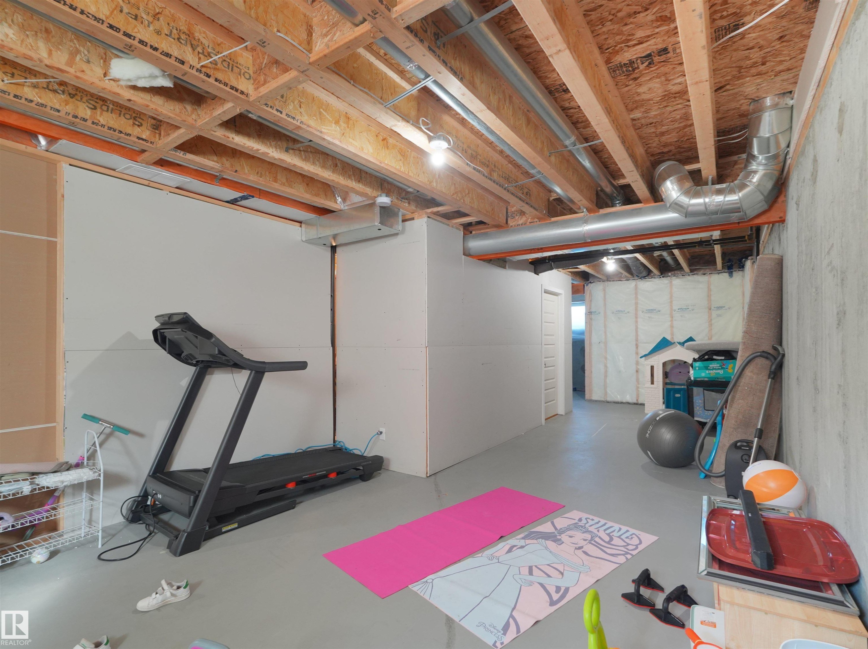 Unfinished basement space featuring exposed wood joists and visible ductwork - #30 4137 76 St Nw, Edmonton, AB