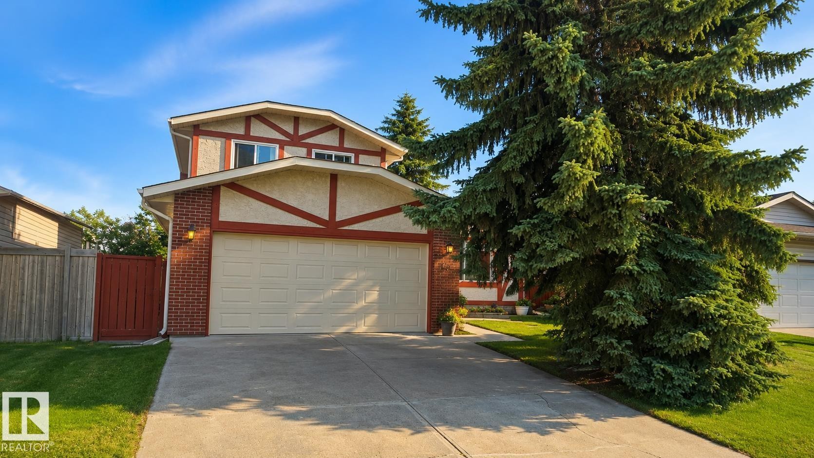 Two-story residence featuring a two-car garage, brick facade, and a decorative gable - 1022 106 Street Nw, Edmonton, AB - Outdoor