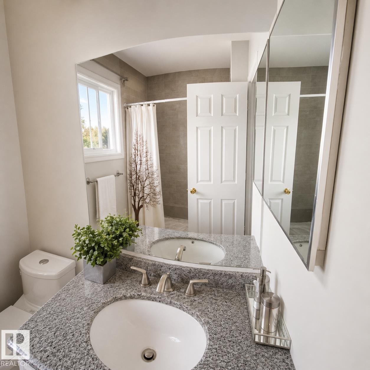 Bathroom featuring a dual vanity with undermount sinks, granite countertop, and brushed nickel fixtures - 1022 106 Street Nw, Edmonton, AB - Indoor Photo Showing Bathroom