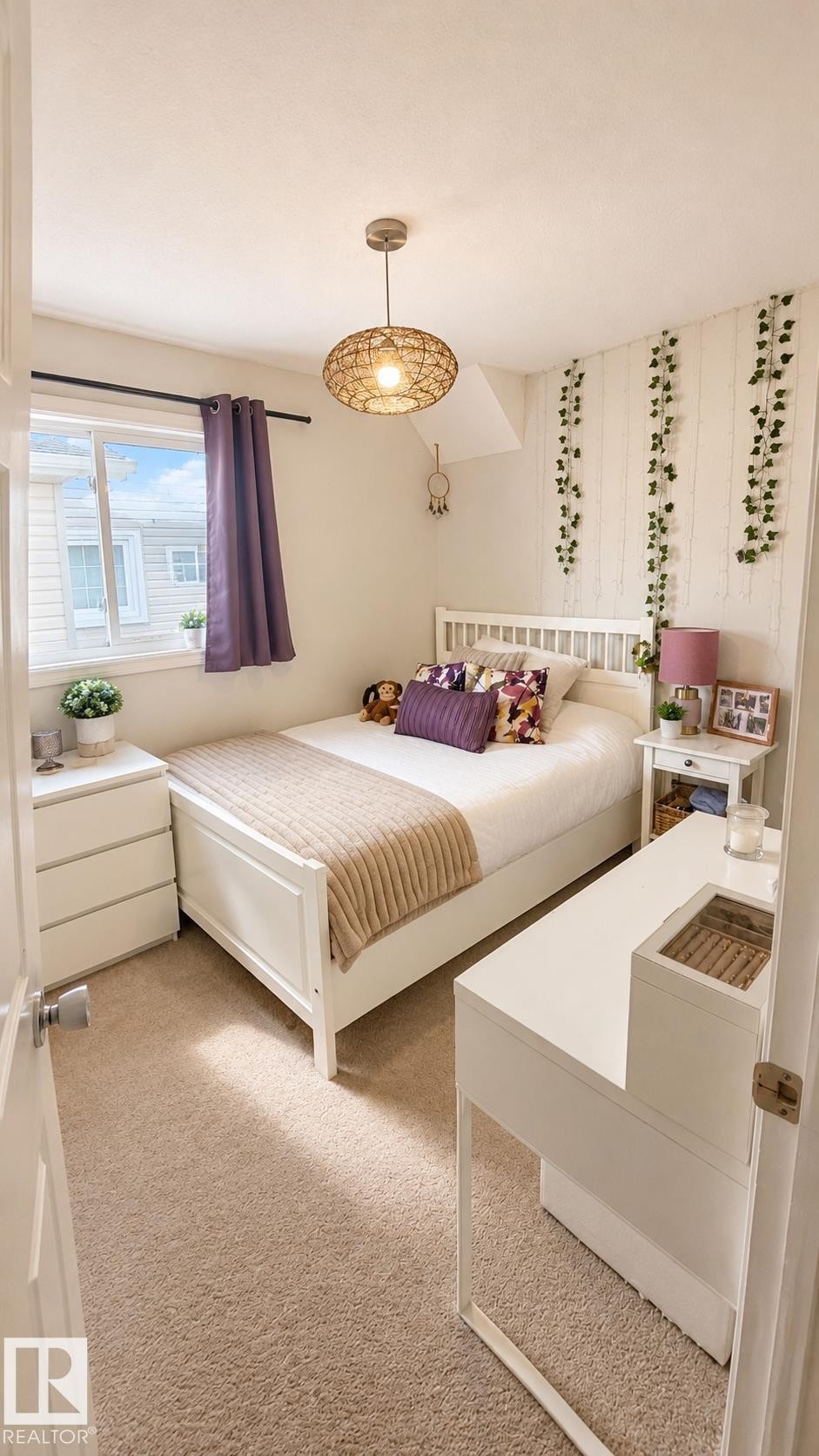Carpeted room featuring a white bed frame, a built-in window, a modern pendant light fixture, and white built-in cabinetry - 1022 106 Street Nw, Edmonton, AB - Indoor Photo Showing Bedroom