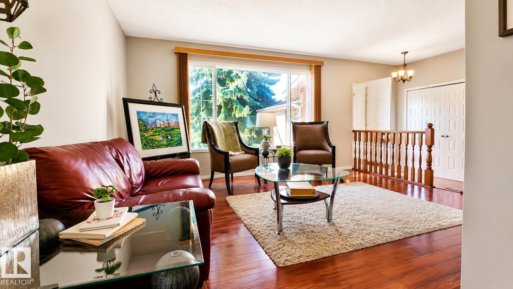Bright living area featuring wide plank wood-finish flooring - 1022 106 Street Nw, Edmonton, AB - Indoor Photo Showing Living Room