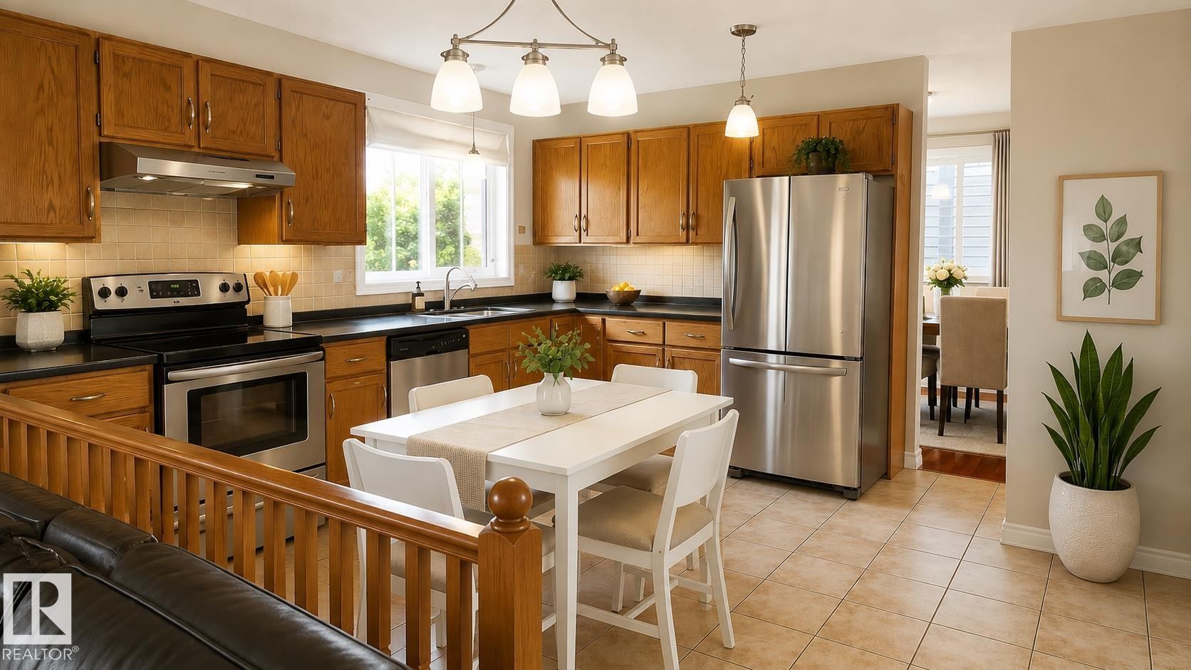 Kitchen featuring wood cabinetry, black countertops, stainless steel appliances, and tiled flooring - 1022 106 Street Nw, Edmonton, AB - Indoor Photo Showing Kitchen