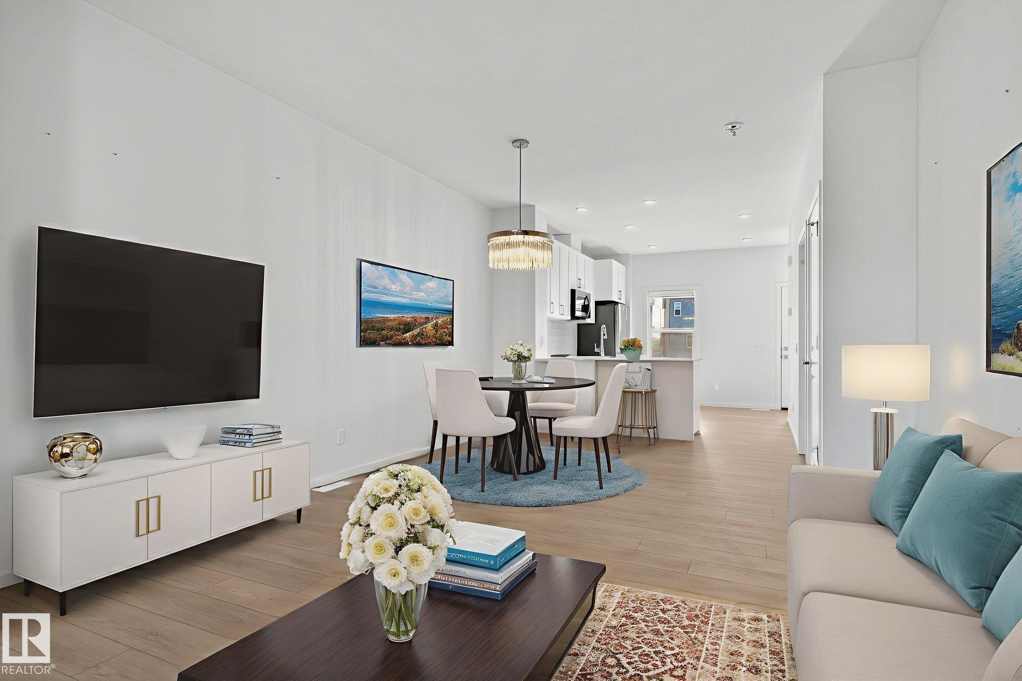 Open-concept living area featuring wood-finish flooring, recessed lighting, and crisp white walls - 264 Orchards Boulevard Sw, Edmonton, AB - Indoor Photo Showing Living Room