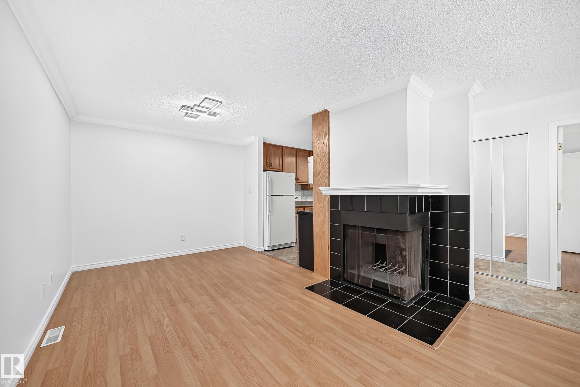 #40 3111 142 Av Nw, Edmonton, AB - Indoor Photo Showing Other Room With Fireplace