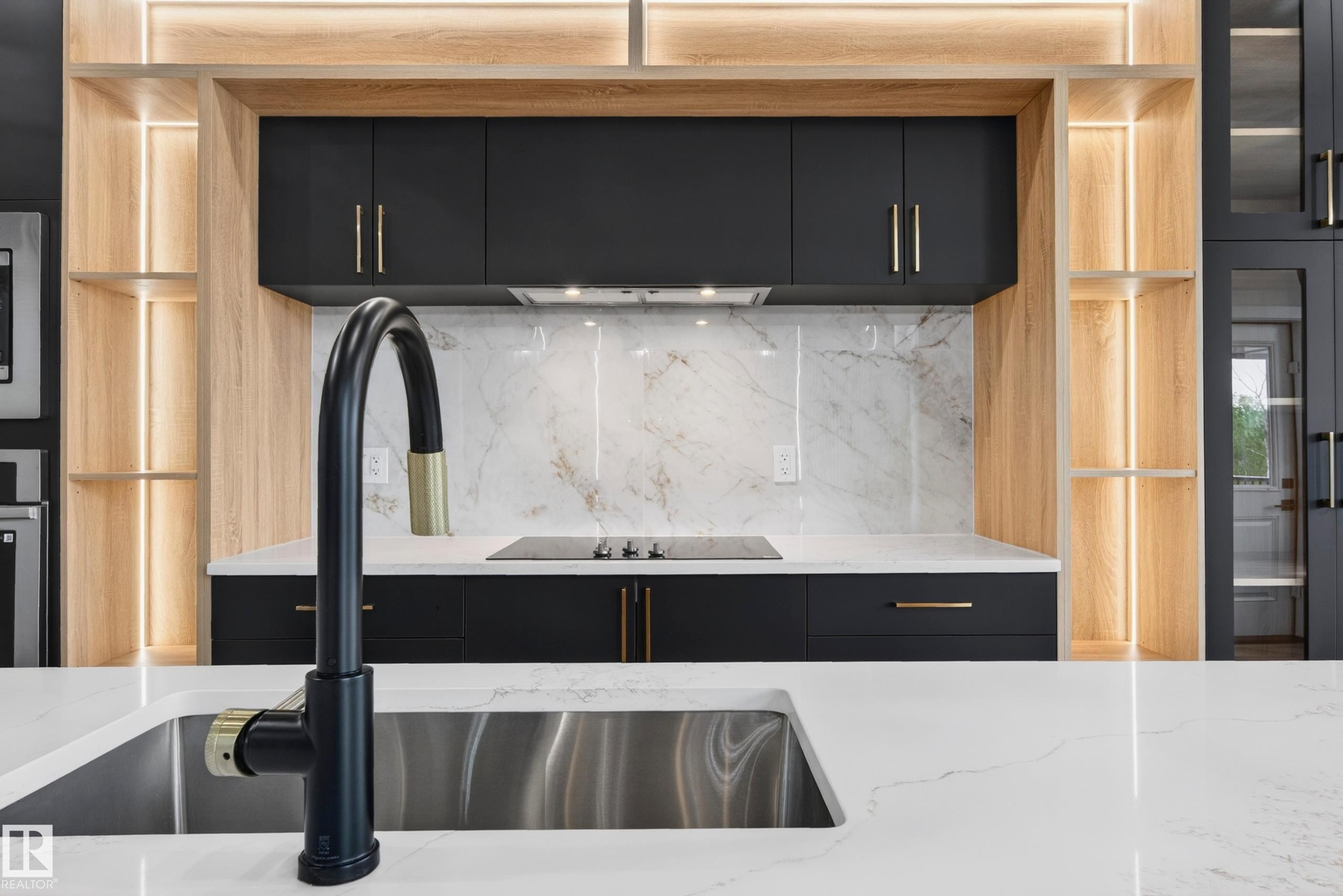 Kitchen island featuring a stainless steel sink with a matte black faucet - 431 172 Avenue, Edmonton, AB - Indoor Photo Showing Kitchen With Upgraded Kitchen