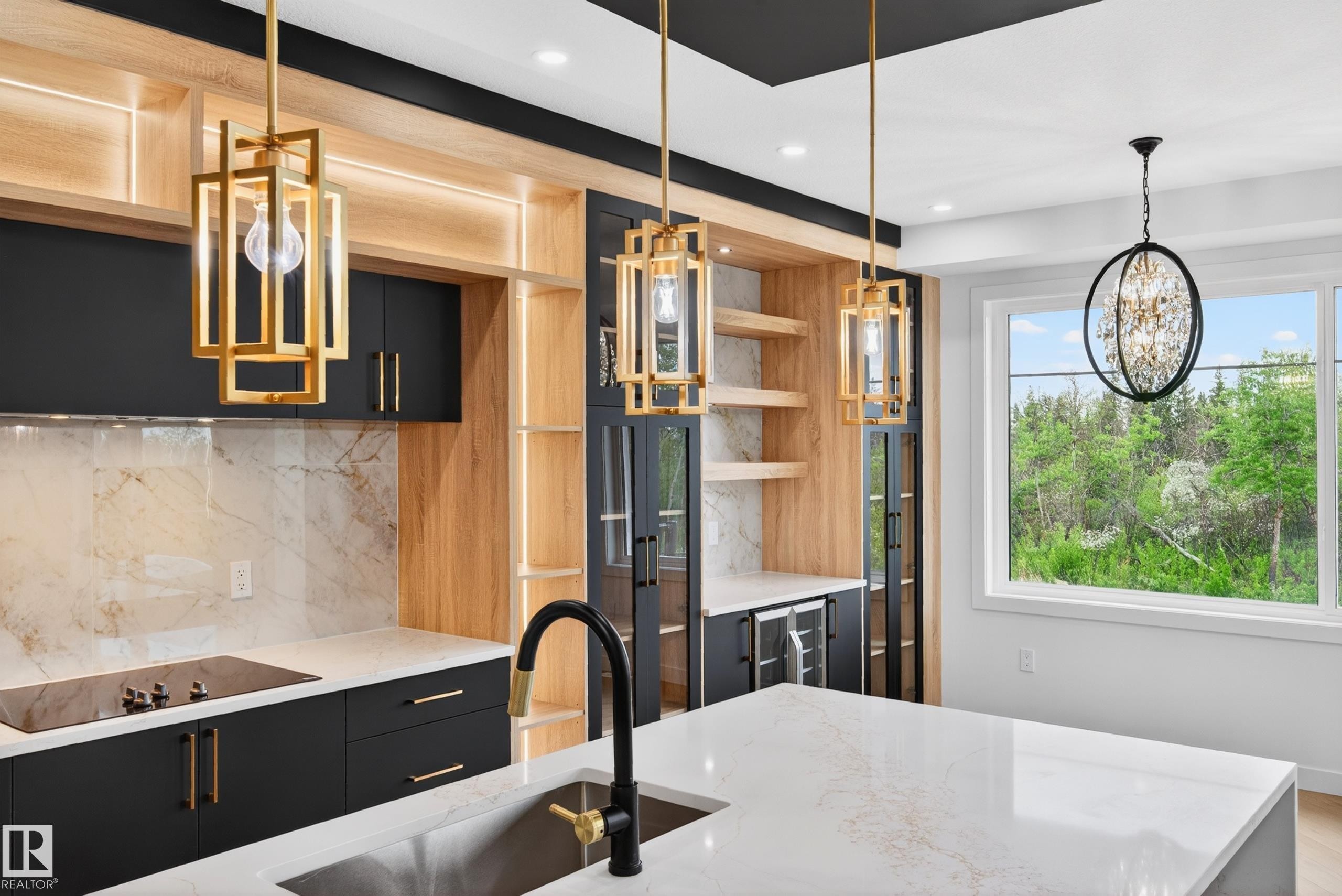 Modern kitchen showcasing a waterfall island with a stainless steel sink and matte black faucet - 431 172 Avenue, Edmonton, AB - Indoor Photo Showing Kitchen With Upgraded Kitchen