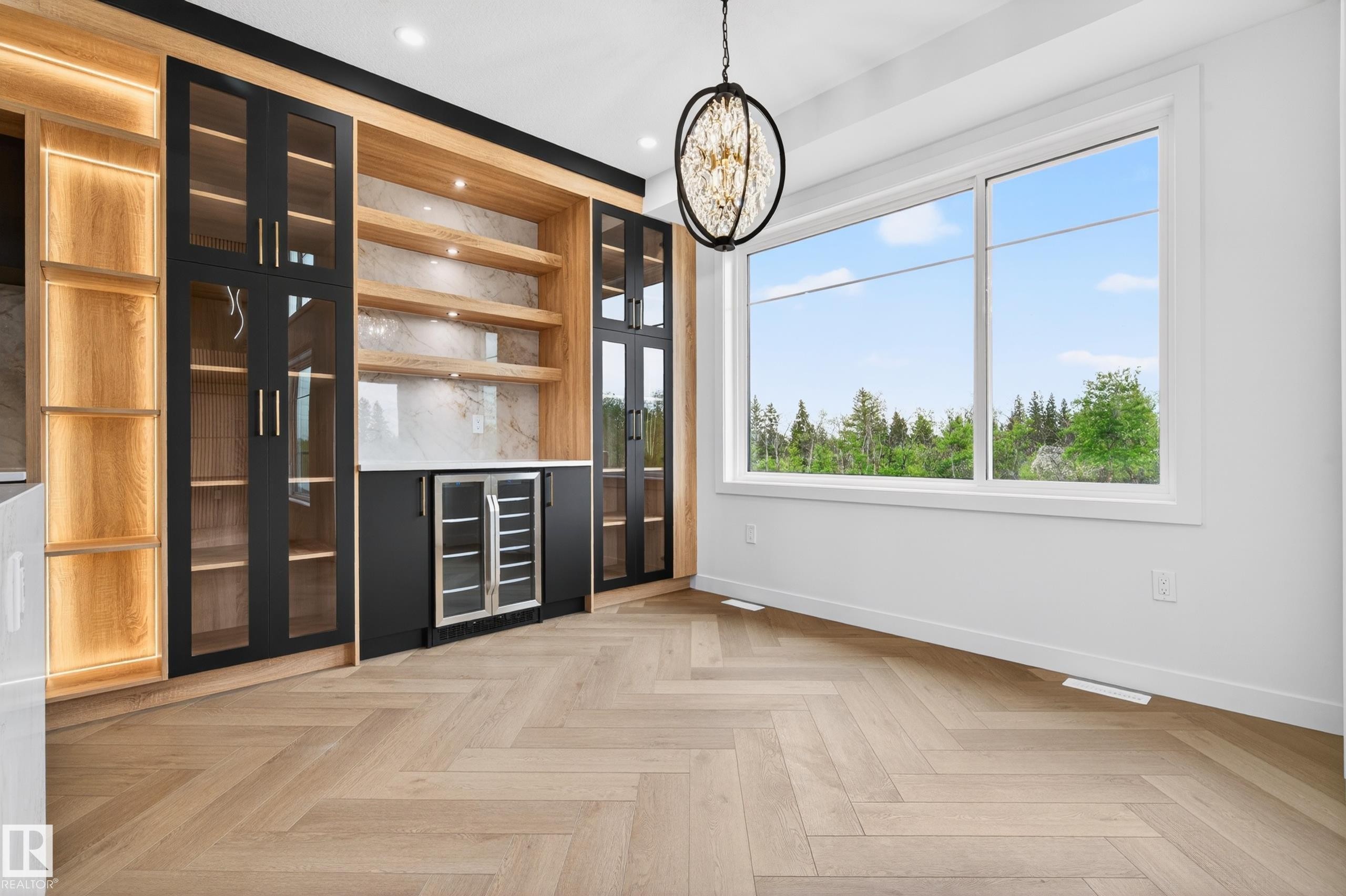 Built-in cabinetry featuring illuminated wood shelving and black-framed glass doors - 431 172 Avenue, Edmonton, AB - Indoor Photo Showing Other Room