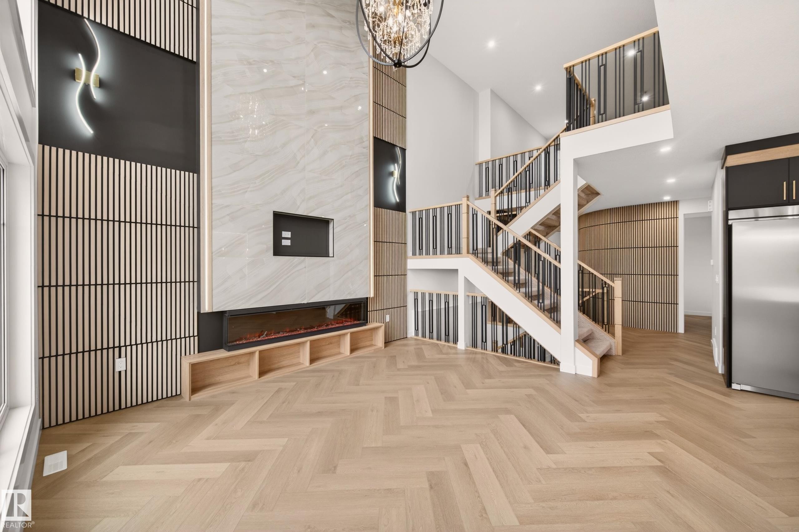 Herringbone wood-finish flooring extending through the space - 431 172 Avenue, Edmonton, AB - Indoor Photo Showing Other Room