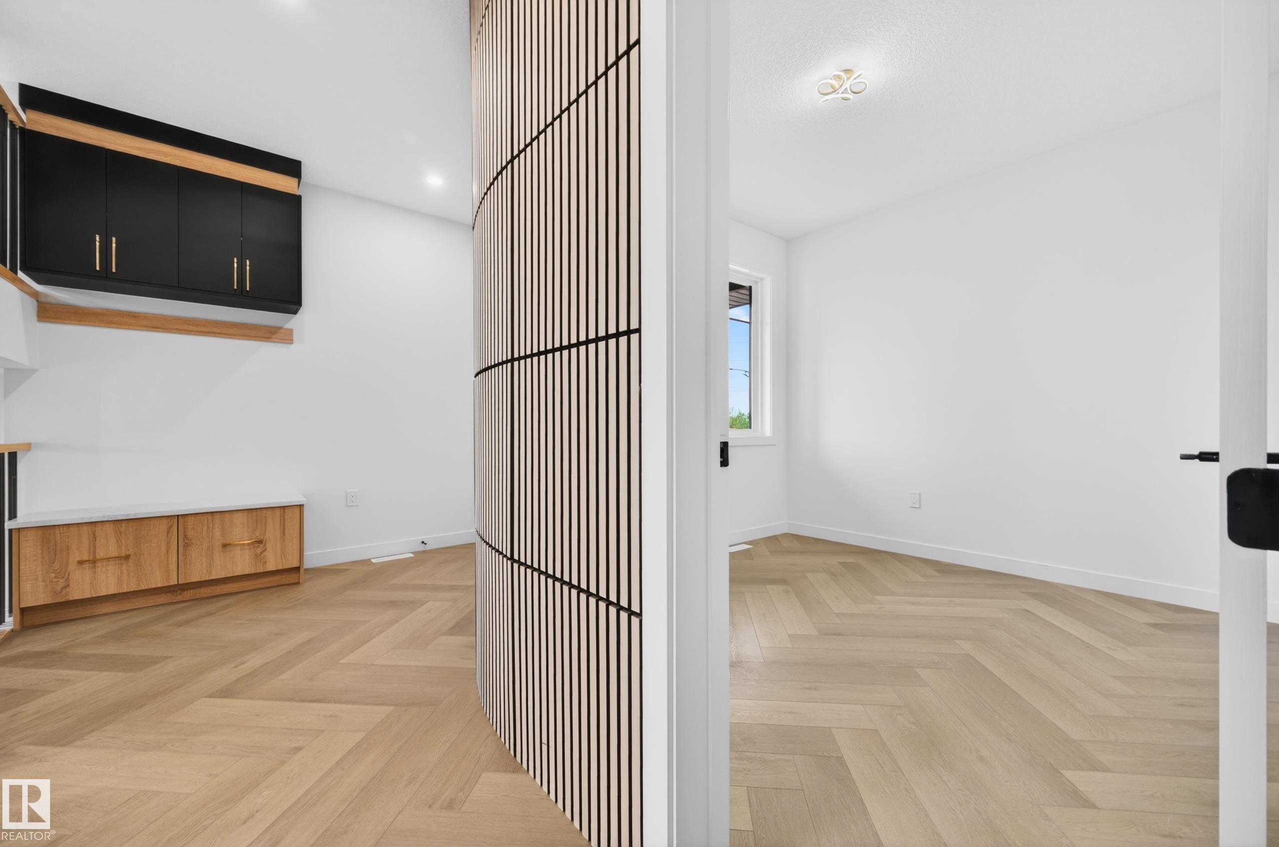 Herringbone wood-finish flooring extending throughout - 431 172 Avenue, Edmonton, AB - Indoor Photo Showing Other Room