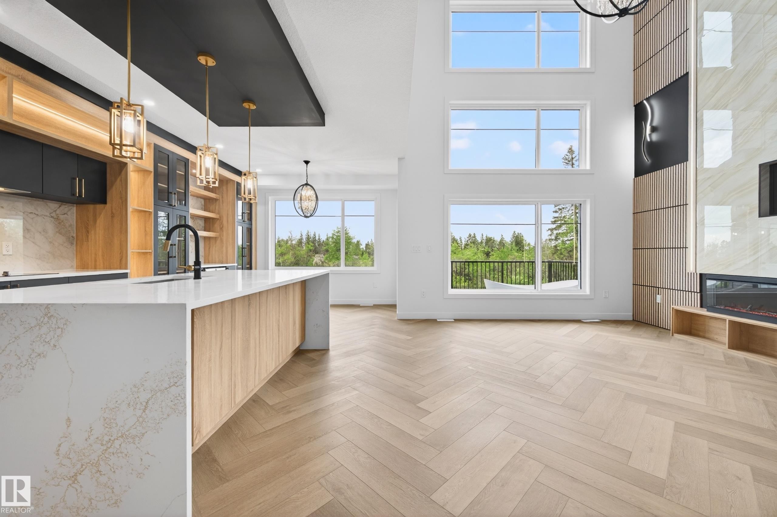Open-concept living space featuring a double-height ceiling and herringbone wood-finish flooring - 431 172 Avenue, Edmonton, AB - Indoor Photo Showing Kitchen