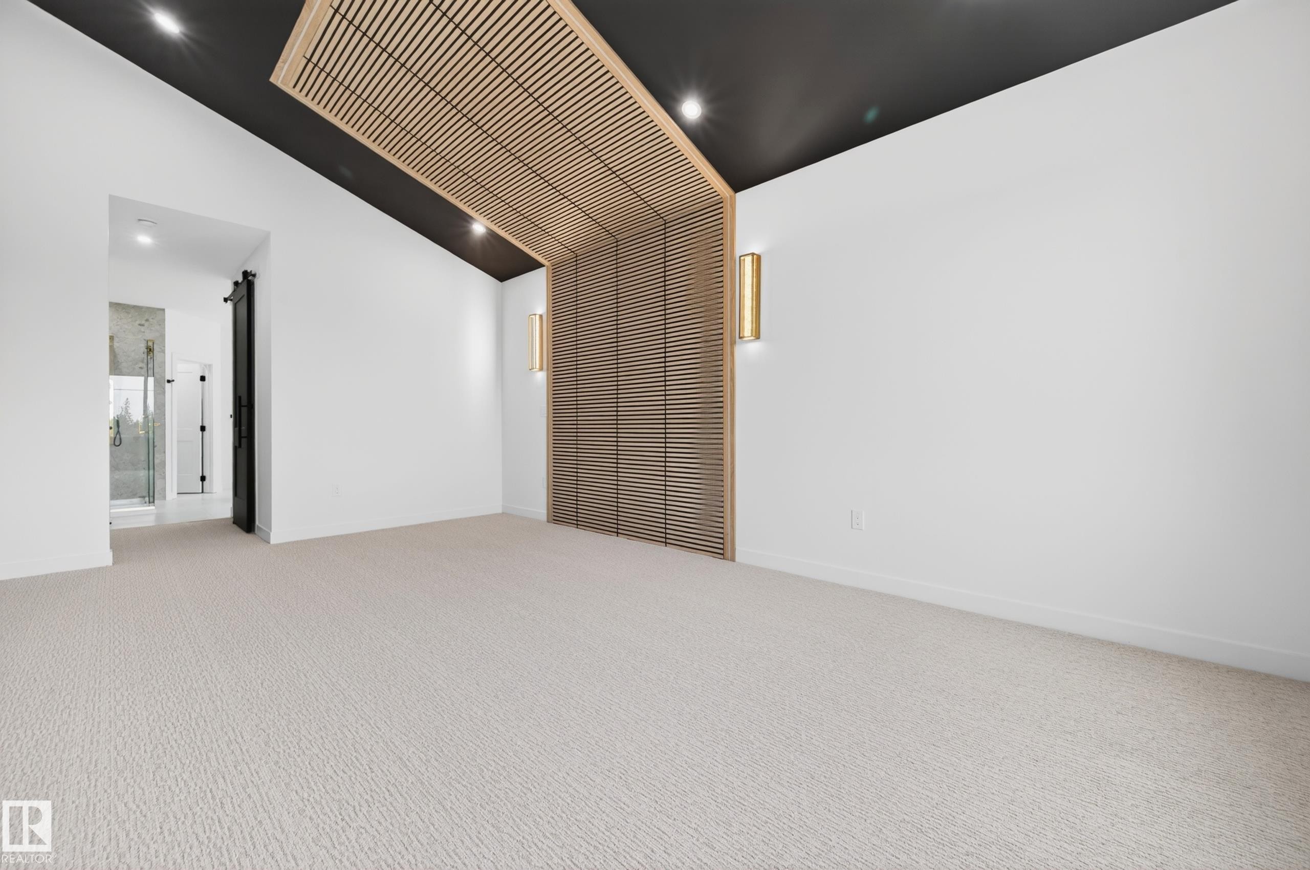 Vaulted ceiling with accent wood slat detailing and integrated lighting - 431 172 Avenue, Edmonton, AB - Indoor Photo Showing Other Room