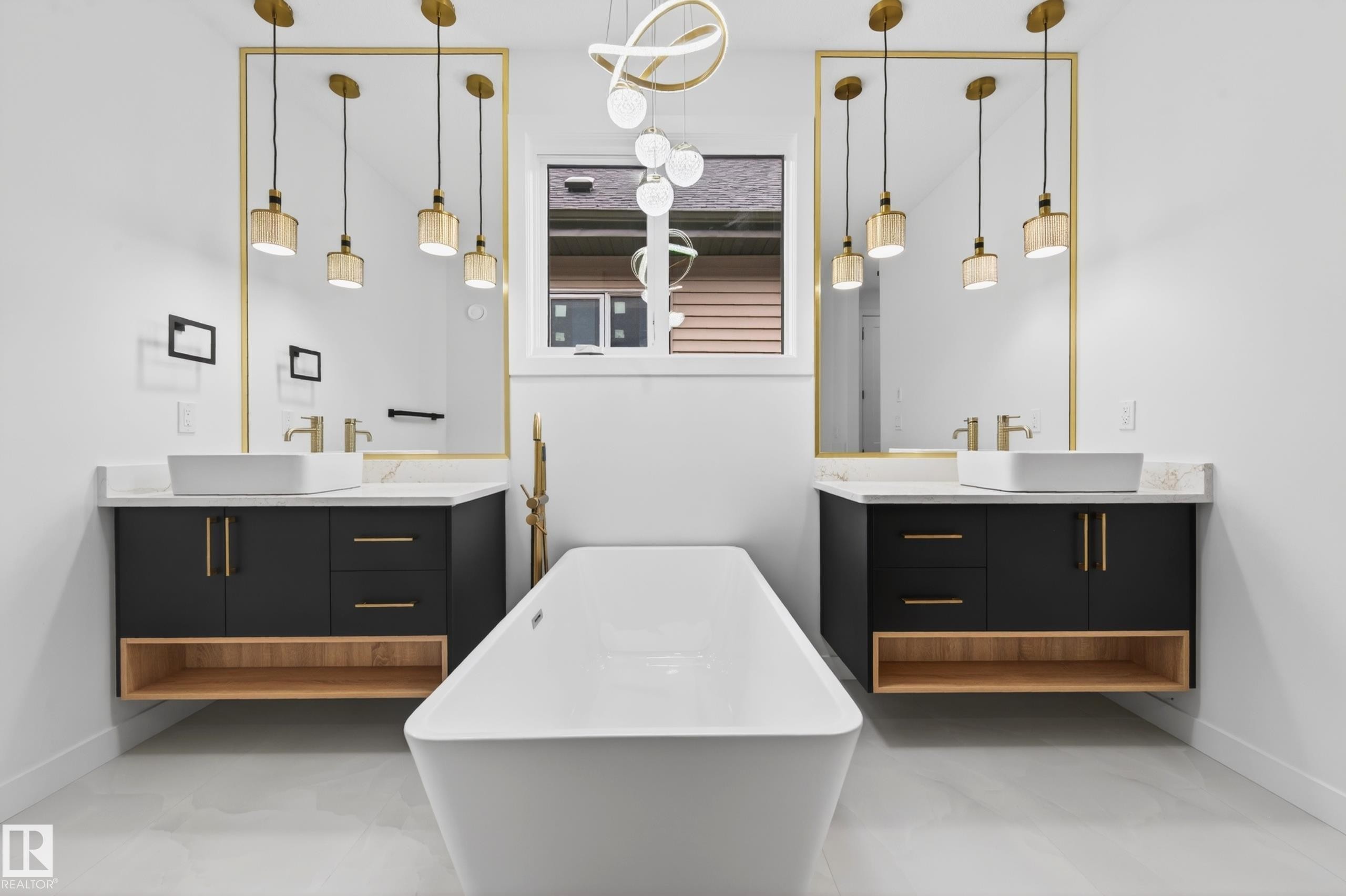 Freestanding soaking tub with floor-mounted fixture, flanked by dual floating vanities featuring black cabinetry, light wood-finish open shelving, and white vessel sinks - 431 172 Avenue, Edmonton, AB - Indoor Photo Showing Bathroom