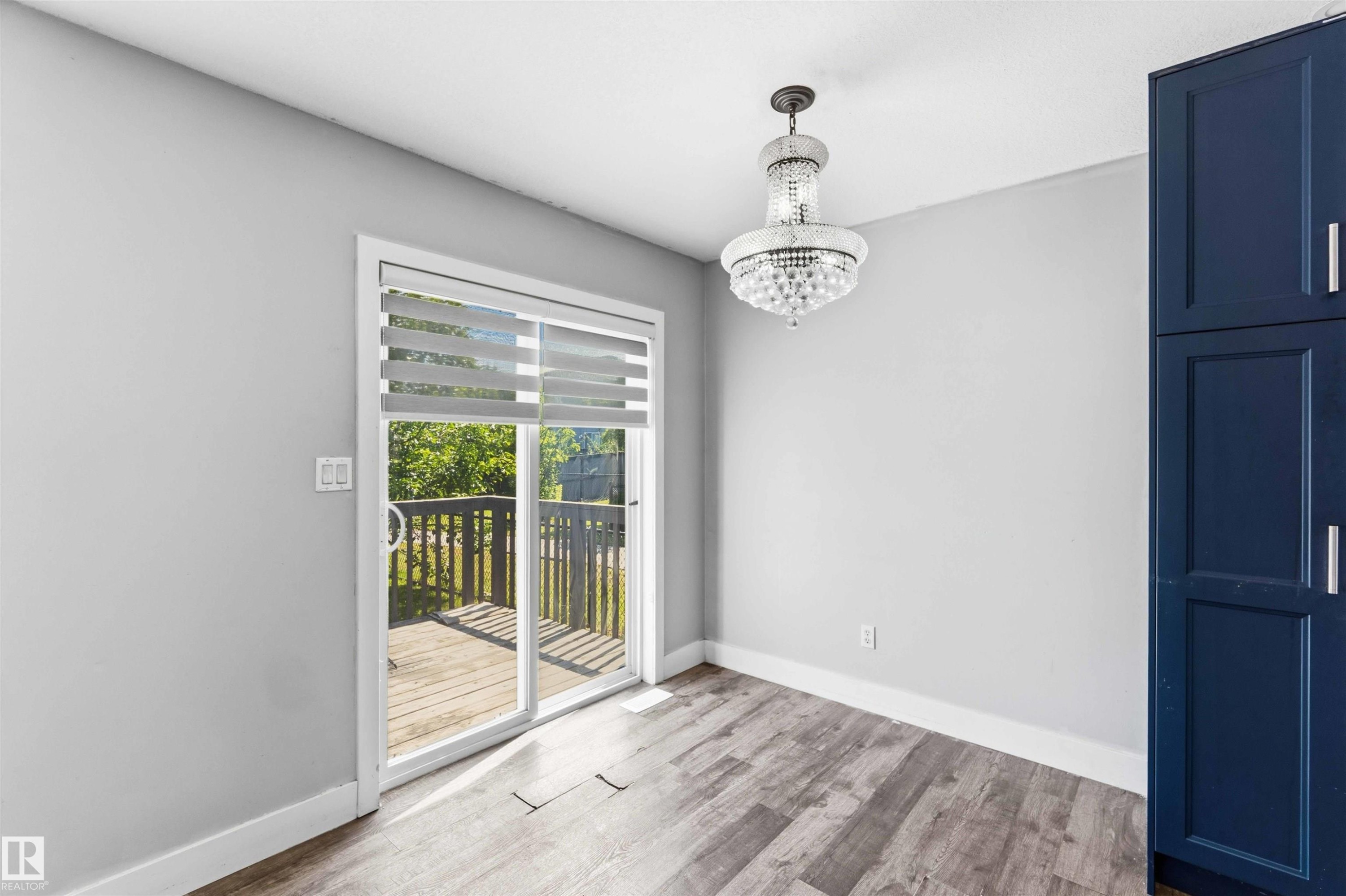 Sliding glass door leading to an outdoor deck - #64 120 Magrath Rd Nw, Edmonton, AB - Indoor Photo Showing Other Room