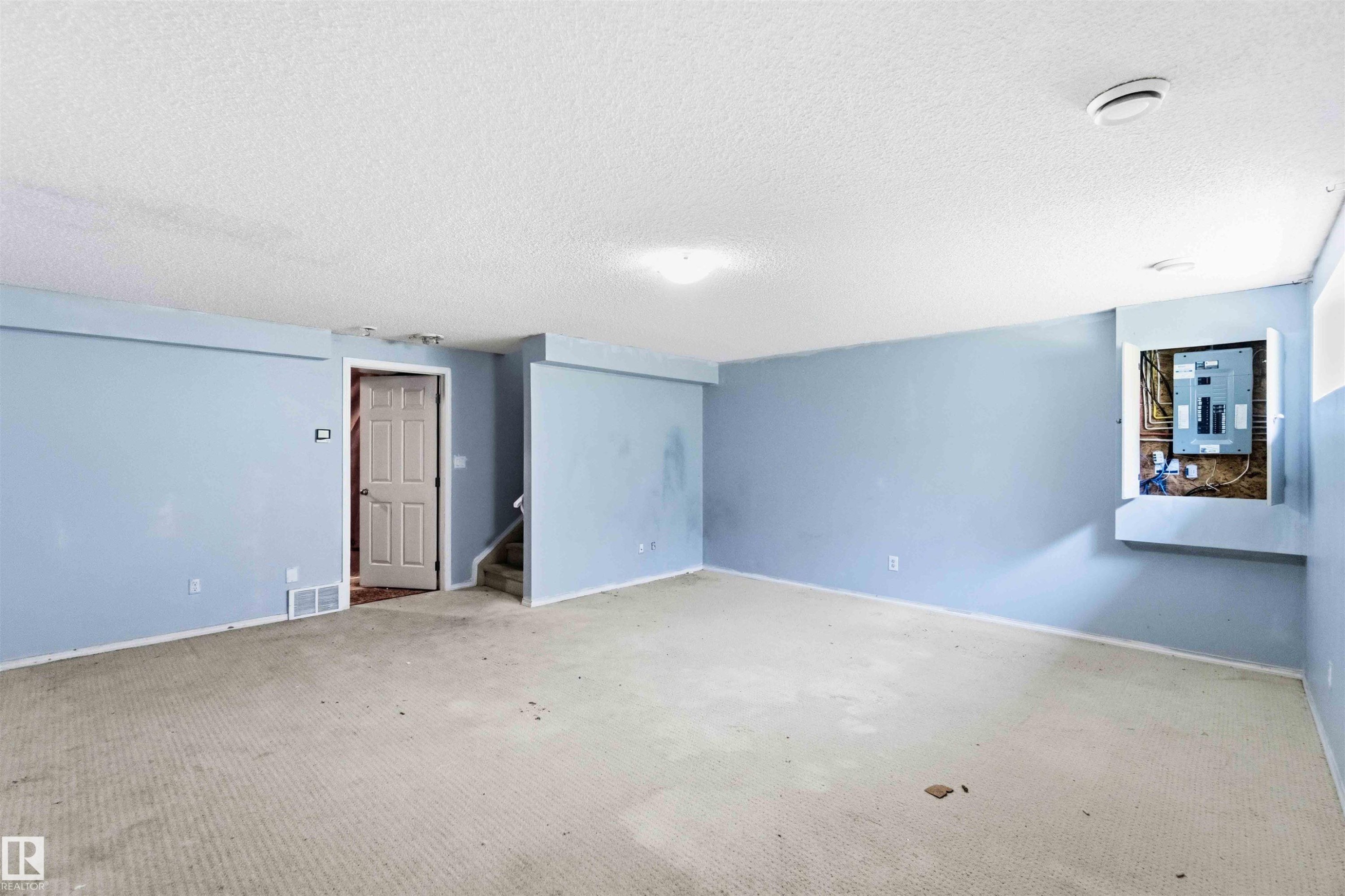 Expansive room featuring light blue walls and a neutral carpet - #64 120 Magrath Rd Nw, Edmonton, AB - Indoor Photo Showing Other Room