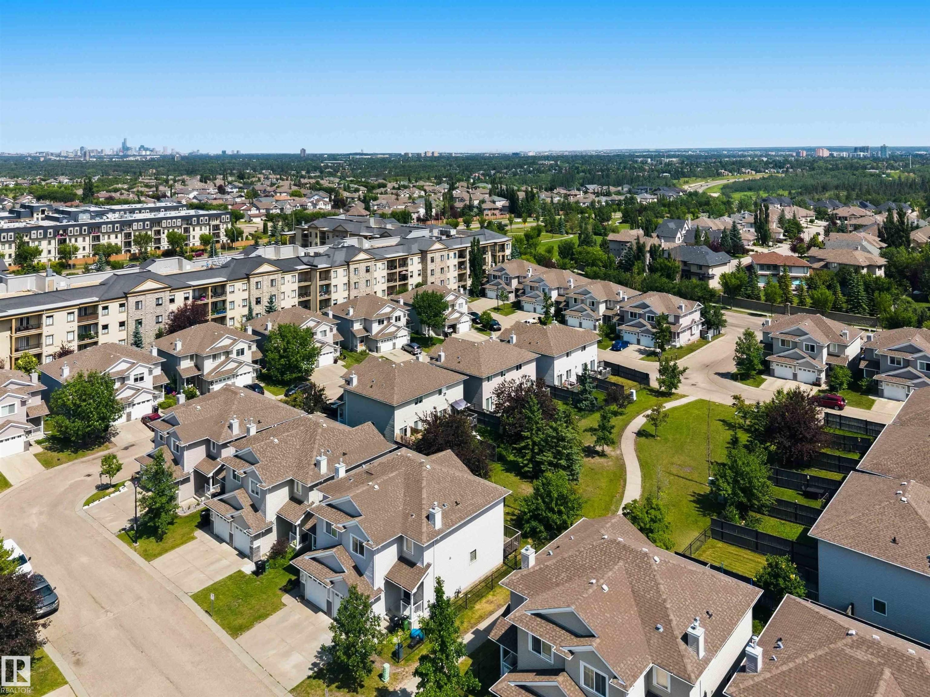 Aerial perspective showcasing a residential community with varied architectural styles - #64 120 Magrath Rd Nw, Edmonton, AB - Outdoor With View