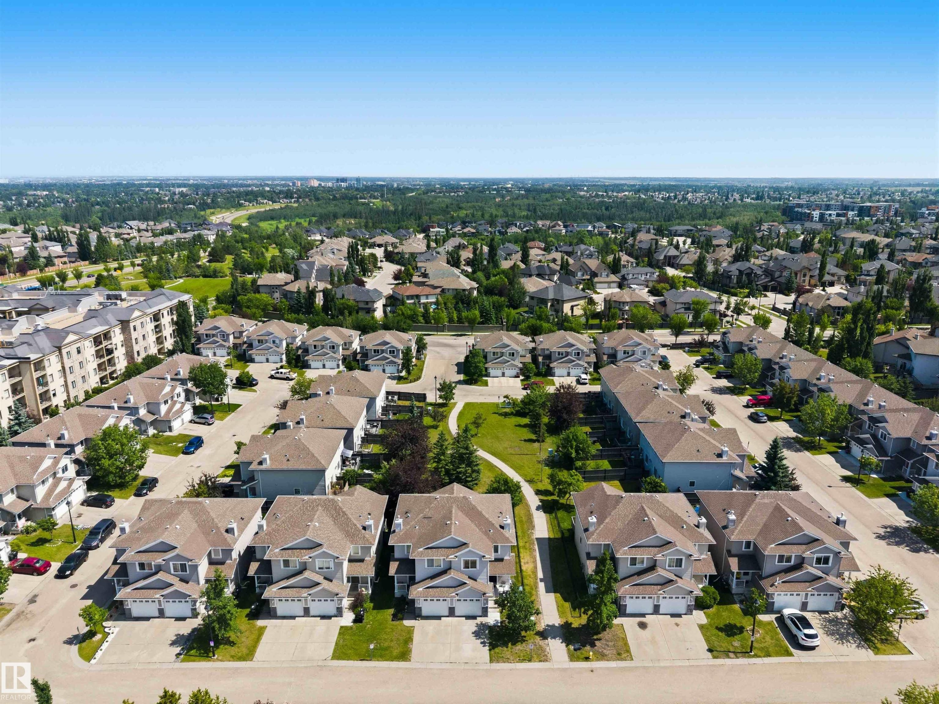 Aerial perspective showcasing a residential development with multiple detached and attached homes - #64 120 Magrath Rd Nw, Edmonton, AB - Outdoor With View