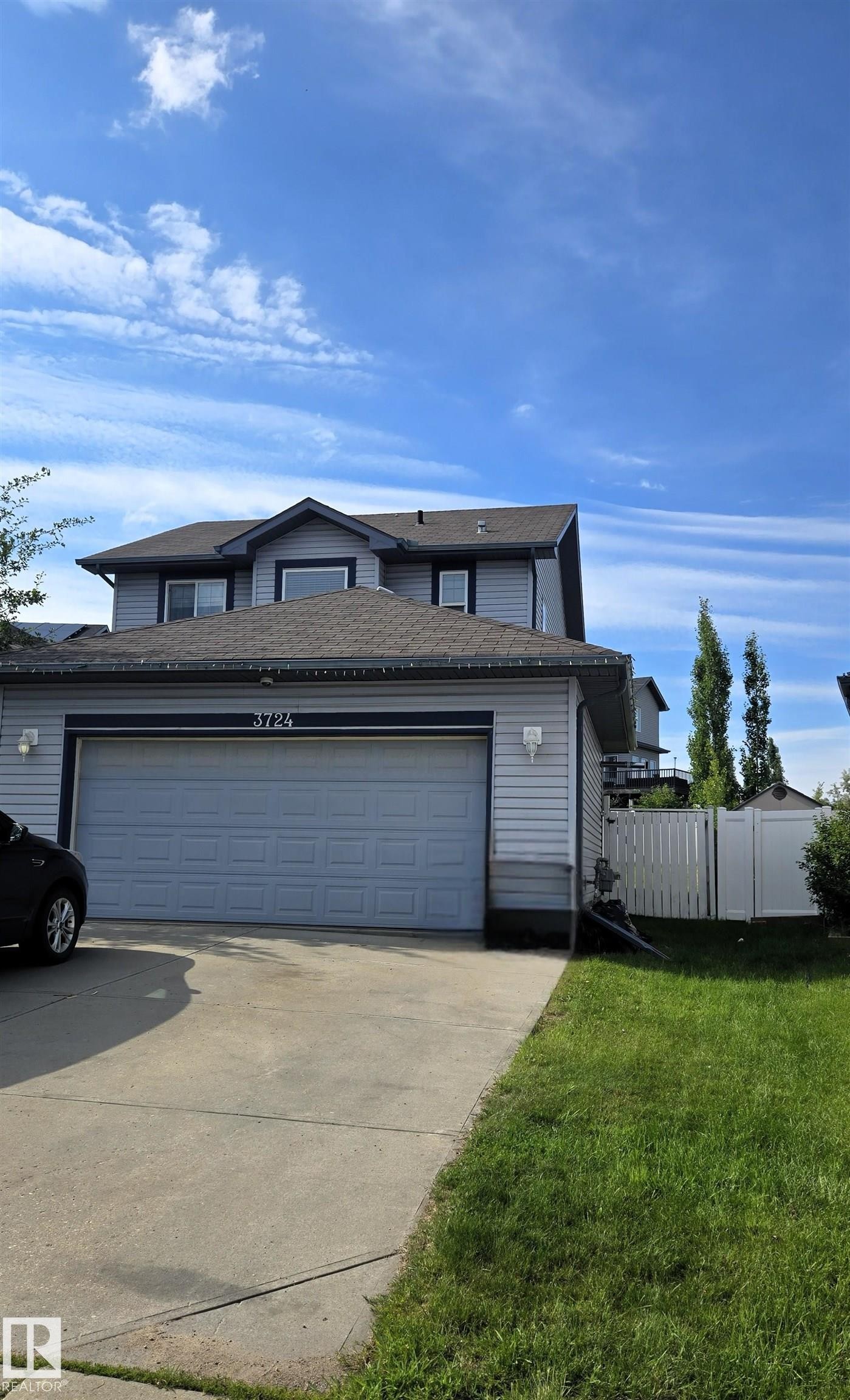 Two-story residence featuring light gray siding with dark trim accents and a shingled roof - 3724 163 Avenue Nw, Edmonton, AB - Outdoor