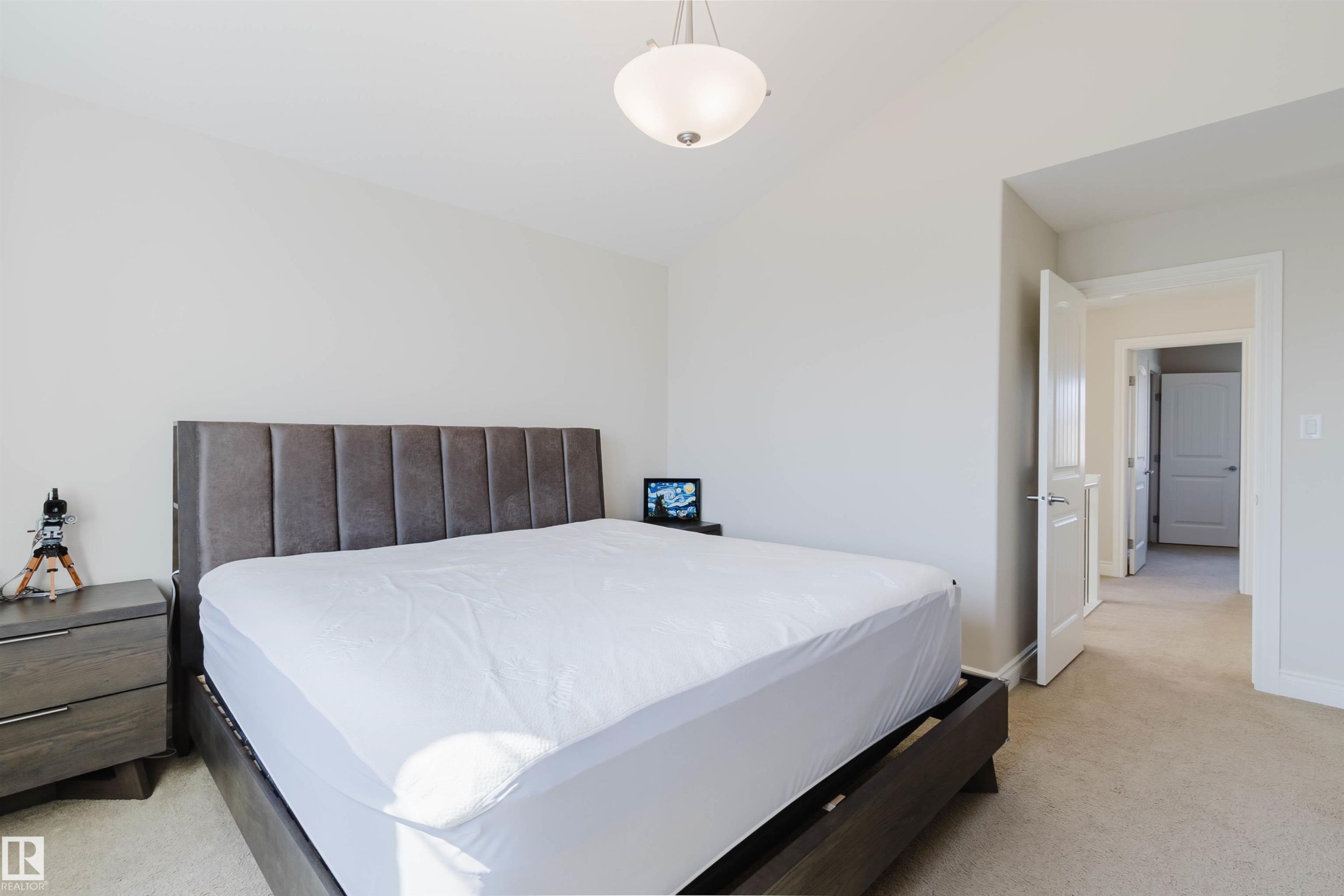 Spacious room featuring vaulted ceilings, light neutral wall tones, and plush carpeting - 17348 6 Avenue Sw, Edmonton, AB - Indoor Photo Showing Bedroom