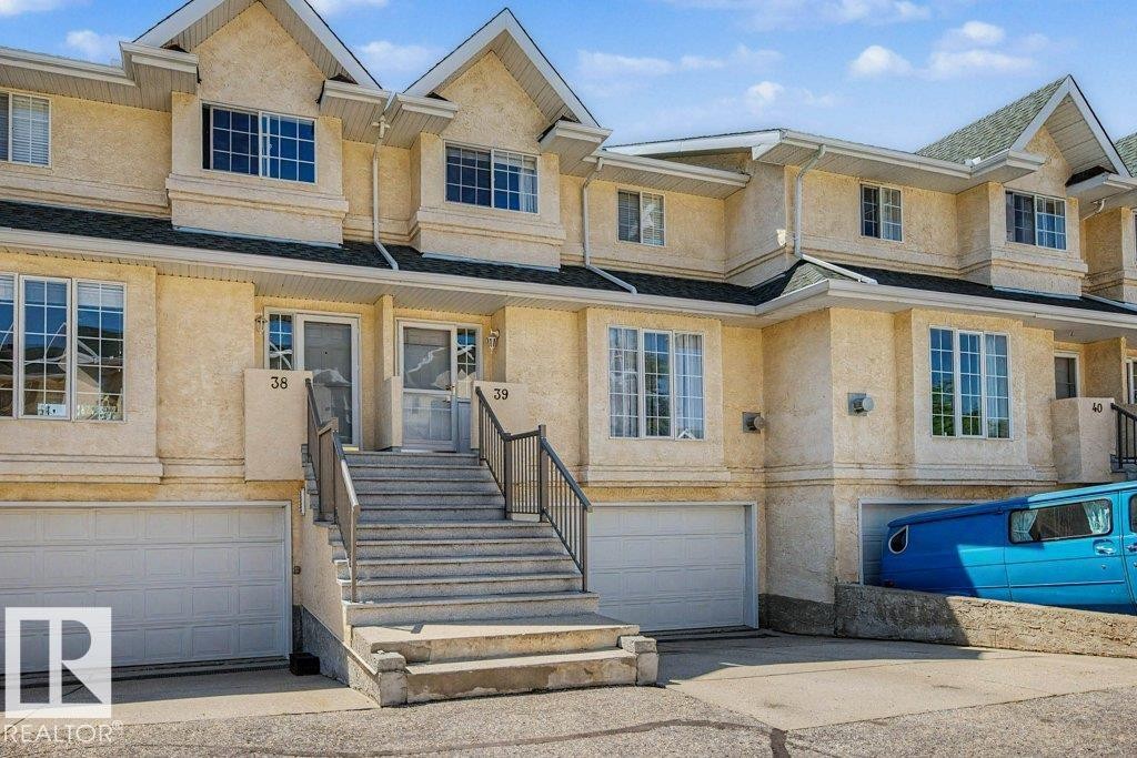 Multi-level townhome featuring a stucco exterior and gabled rooflines - #39 2419 133 Av Nw, Edmonton, AB - Outdoor With Facade