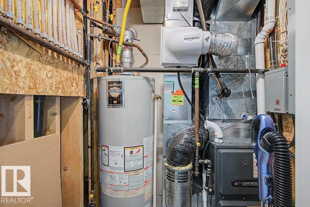 Water heater, furnace system, and humidifier installation - #39 2419 133 Av Nw, Edmonton, AB - Indoor Photo Showing Basement