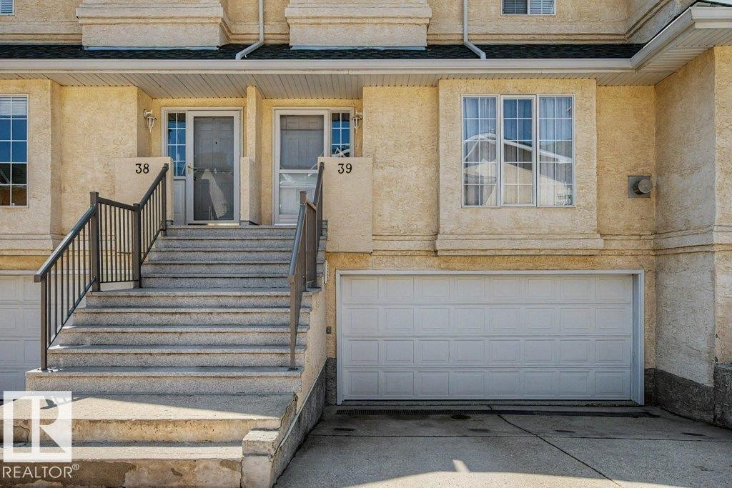 Stucco exterior with multiple windows - #39 2419 133 Av Nw, Edmonton, AB - Outdoor With Exterior