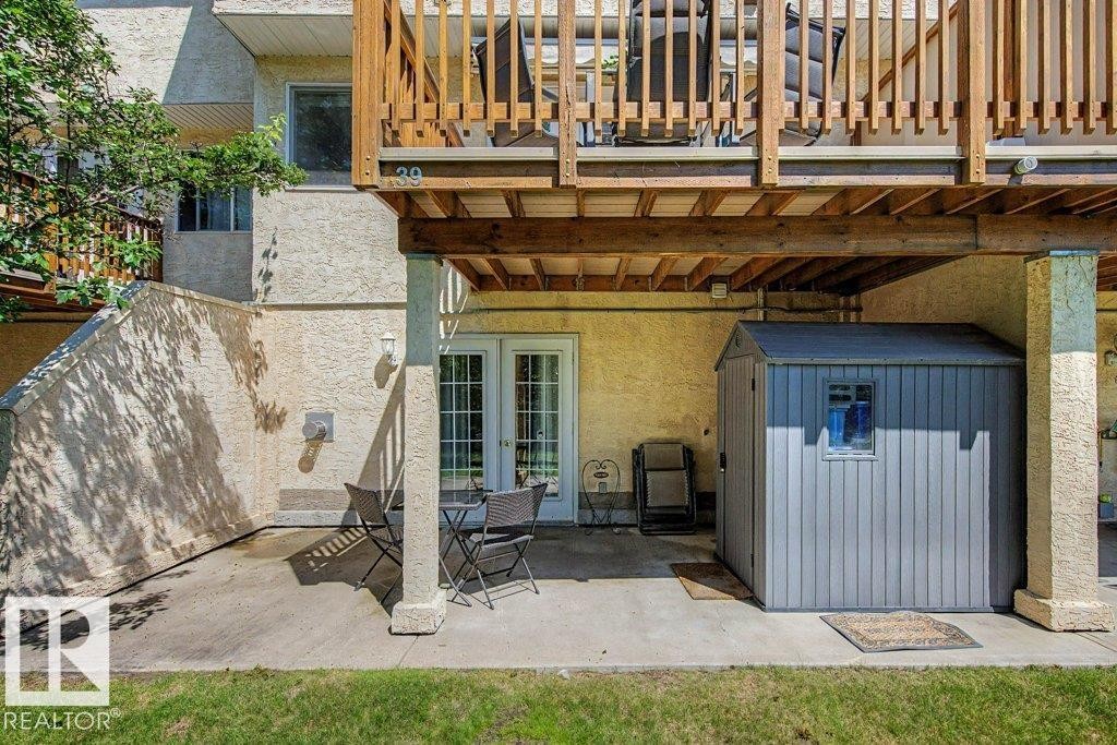 Ground-level patio with direct outdoor access via double French doors - #39 2419 133 Av Nw, Edmonton, AB - Outdoor With Exterior