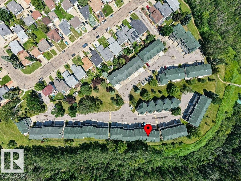 Aerial view of a residential community featuring townhomes with green roofs, surrounded by mature trees - #39 2419 133 Av Nw, Edmonton, AB - Other