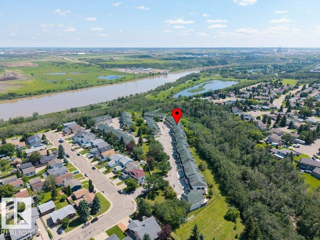 Aerial perspective of a multi-unit residential development bordering a wooded area - #39 2419 133 Av Nw, Edmonton, AB - Outdoor With View