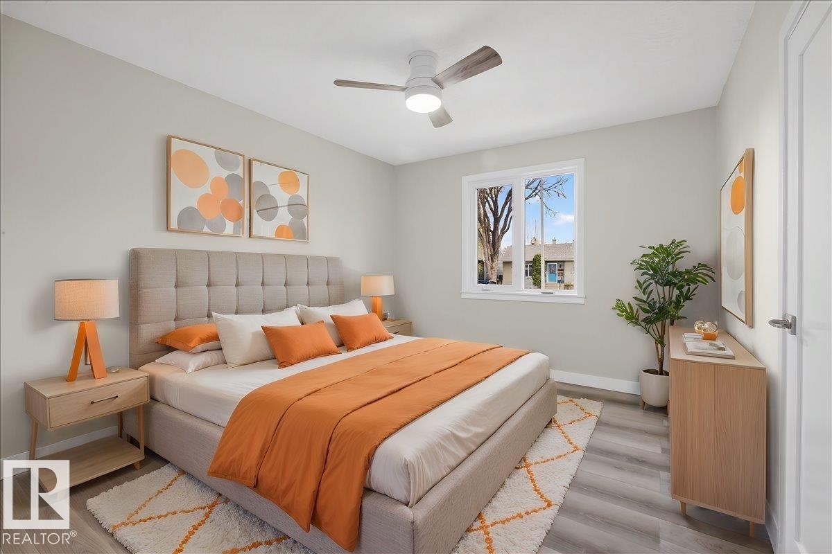 Bright room featuring light gray walls, wood-finish flooring, and a white window - 9723 65 Avenue Nw, Edmonton, AB