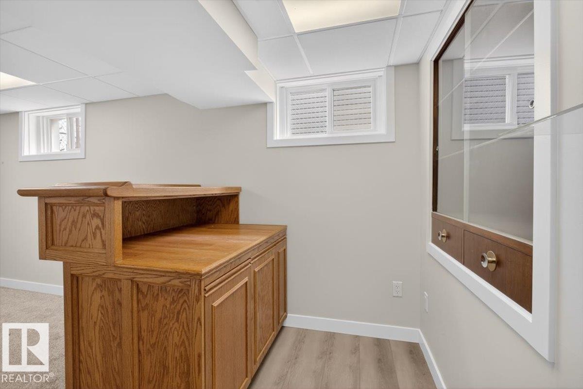 Built-in wood cabinetry with a serving counter and display shelving - 9723 65 Avenue Nw, Edmonton, AB