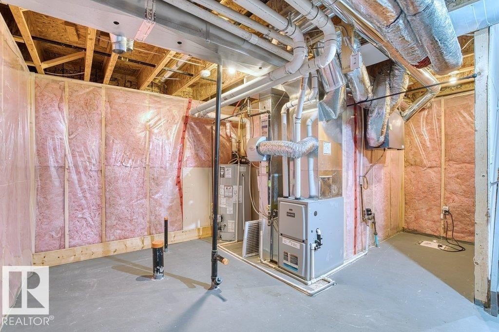 Unfinished basement space featuring exposed wood framing, ceiling joists, and a concrete floor - 1627 167 Street Sw, Edmonton, AB - Indoor Photo Showing Basement
