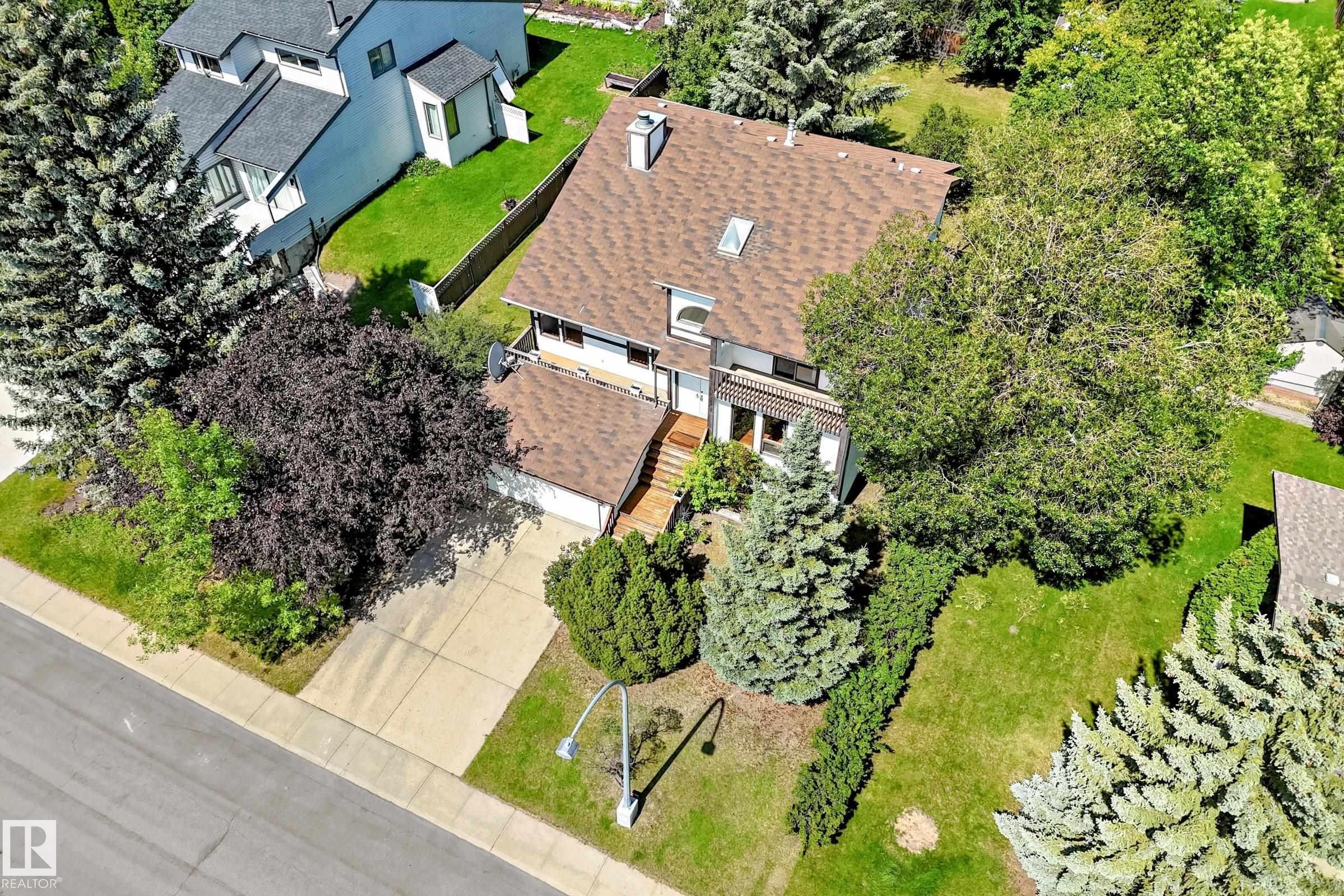Residential property featuring a shingle roof, a front-facing attached garage, and a concrete driveway - 4208 Ramsay Road Nw, Edmonton, AB - Outdoor