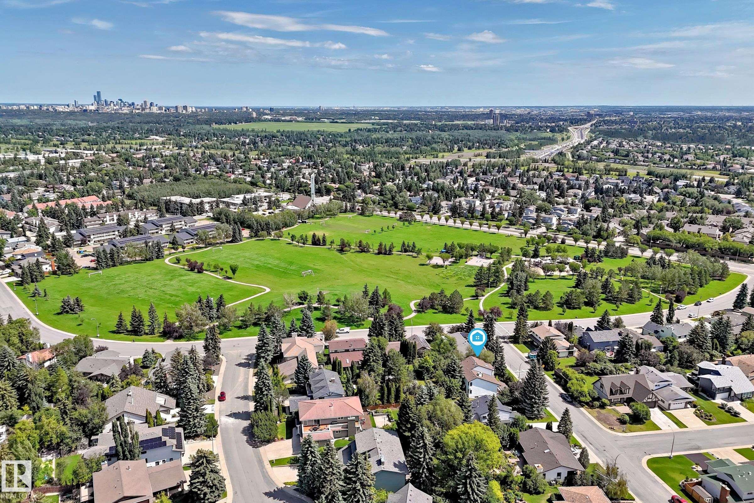 Aerial perspective showcasing expansive green spaces, mature tree-lined streets, and a residential community - 4208 Ramsay Road Nw, Edmonton, AB - Outdoor With View