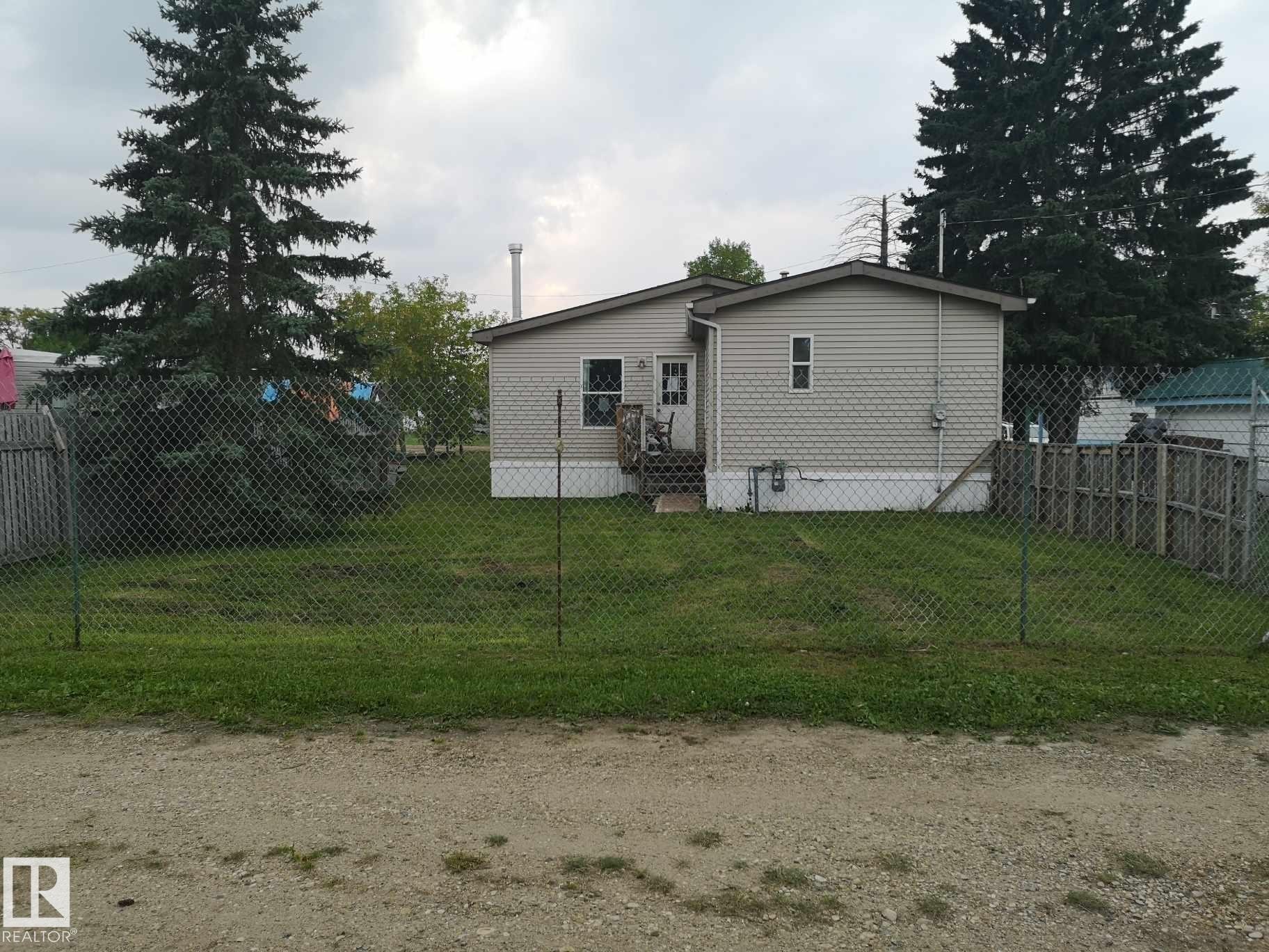 Single-story residence featuring light-colored siding and a covered entry - 5273 50 Street, Mayerthorpe, AB - Outdoor