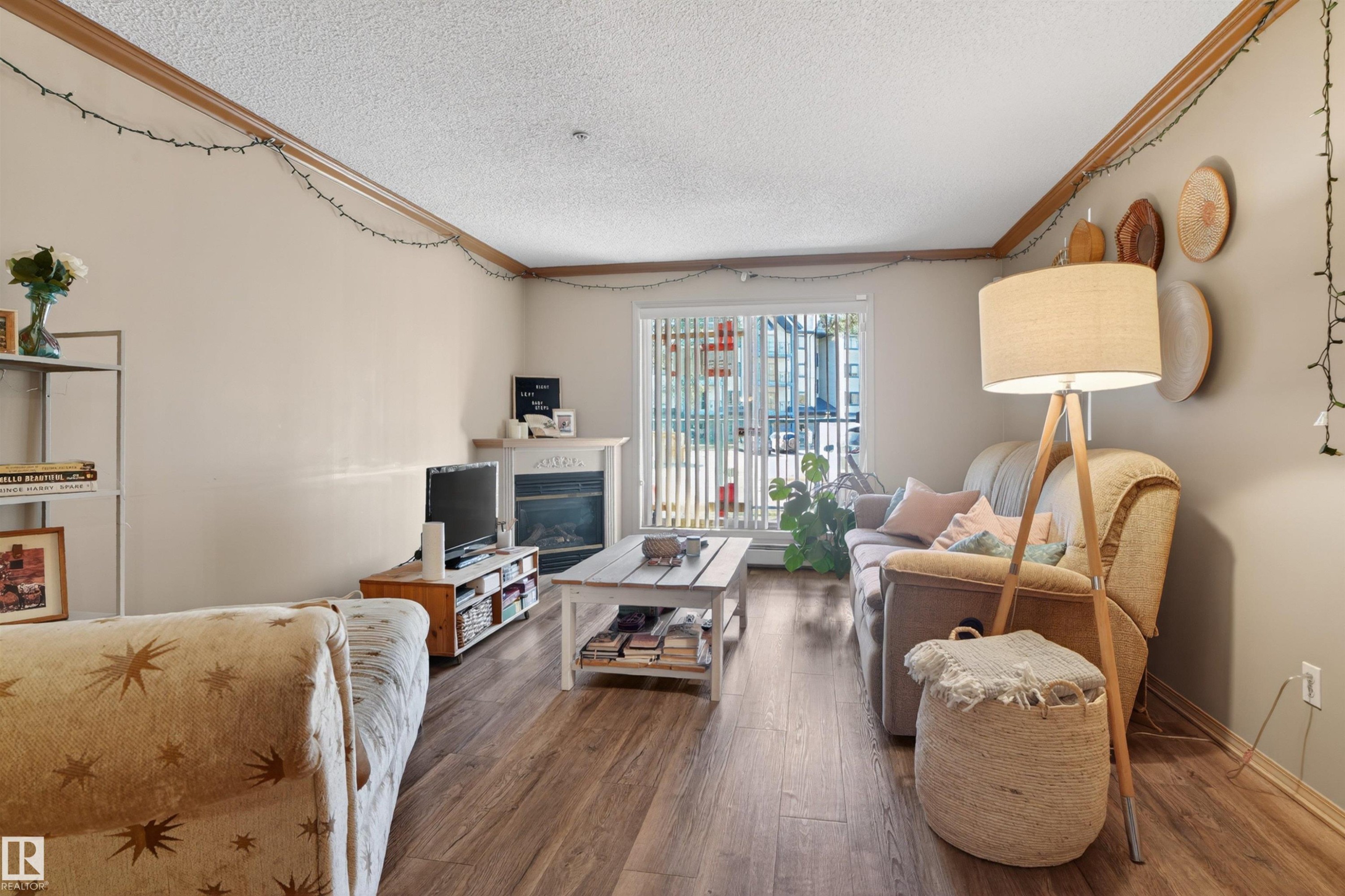 #110 2903 Rabbit Hill Rd Nw, Edmonton, AB - Indoor Photo Showing Living Room With Fireplace