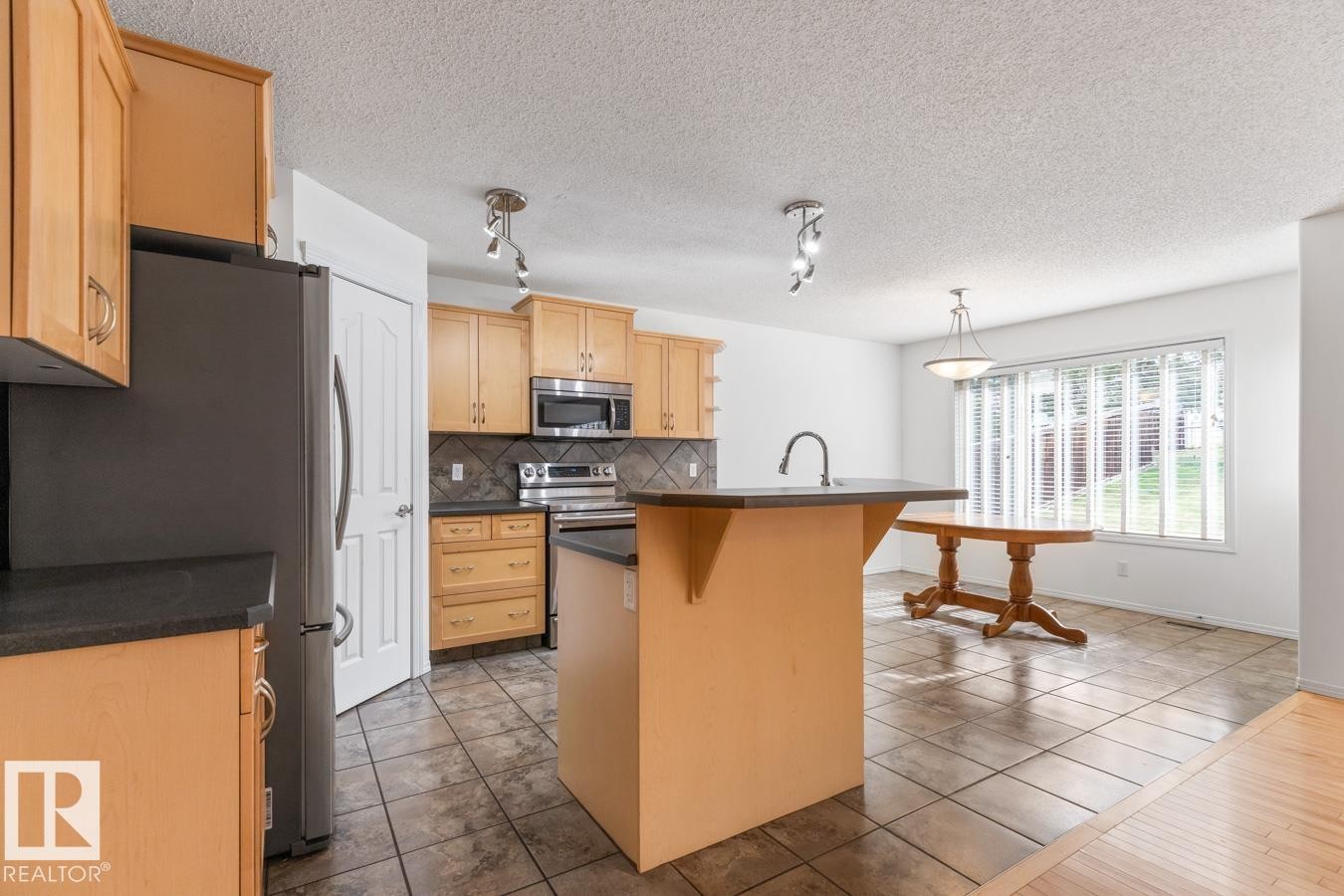 View Of Kitchen And Eating Area. - 4717 60 Street, Beaumont, AB