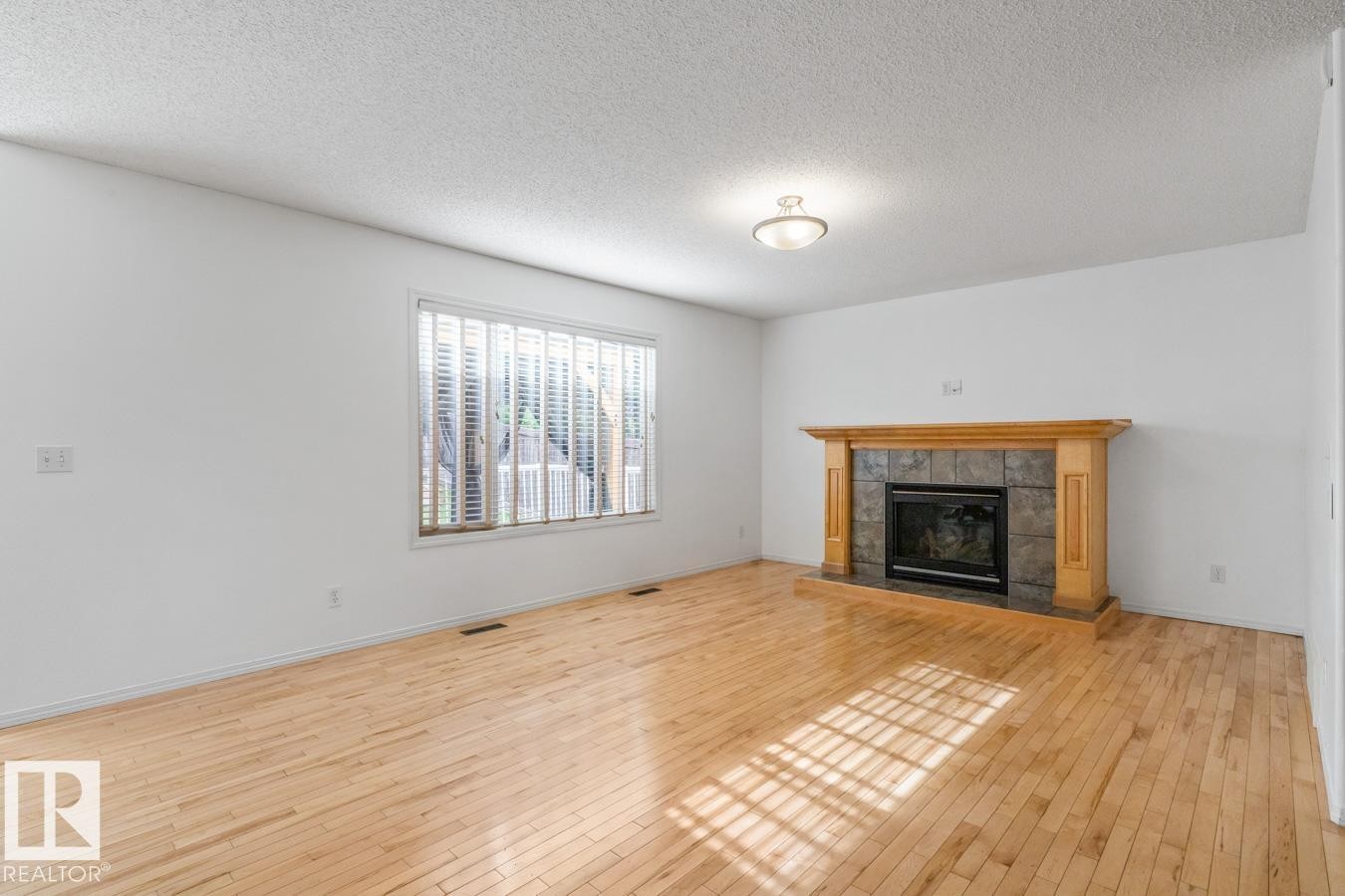 Big Living Room With Maple Flooring & Gas Fireplace. - 4717 60 Street, Beaumont, AB