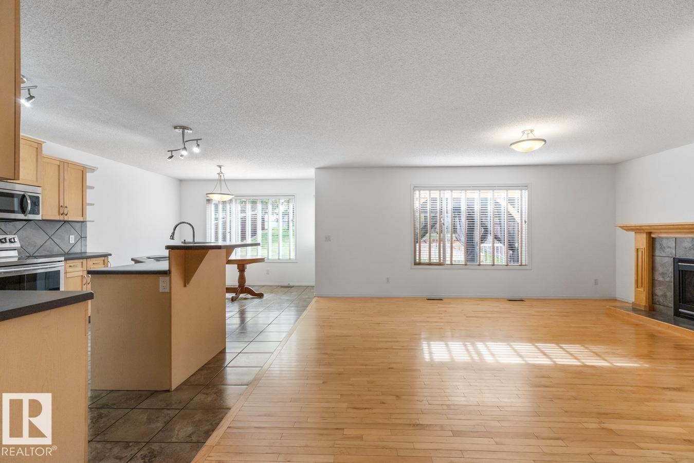 Living Room With Big Window Looking Out Into The Huge Backyard. - 4717 60 Street, Beaumont, AB