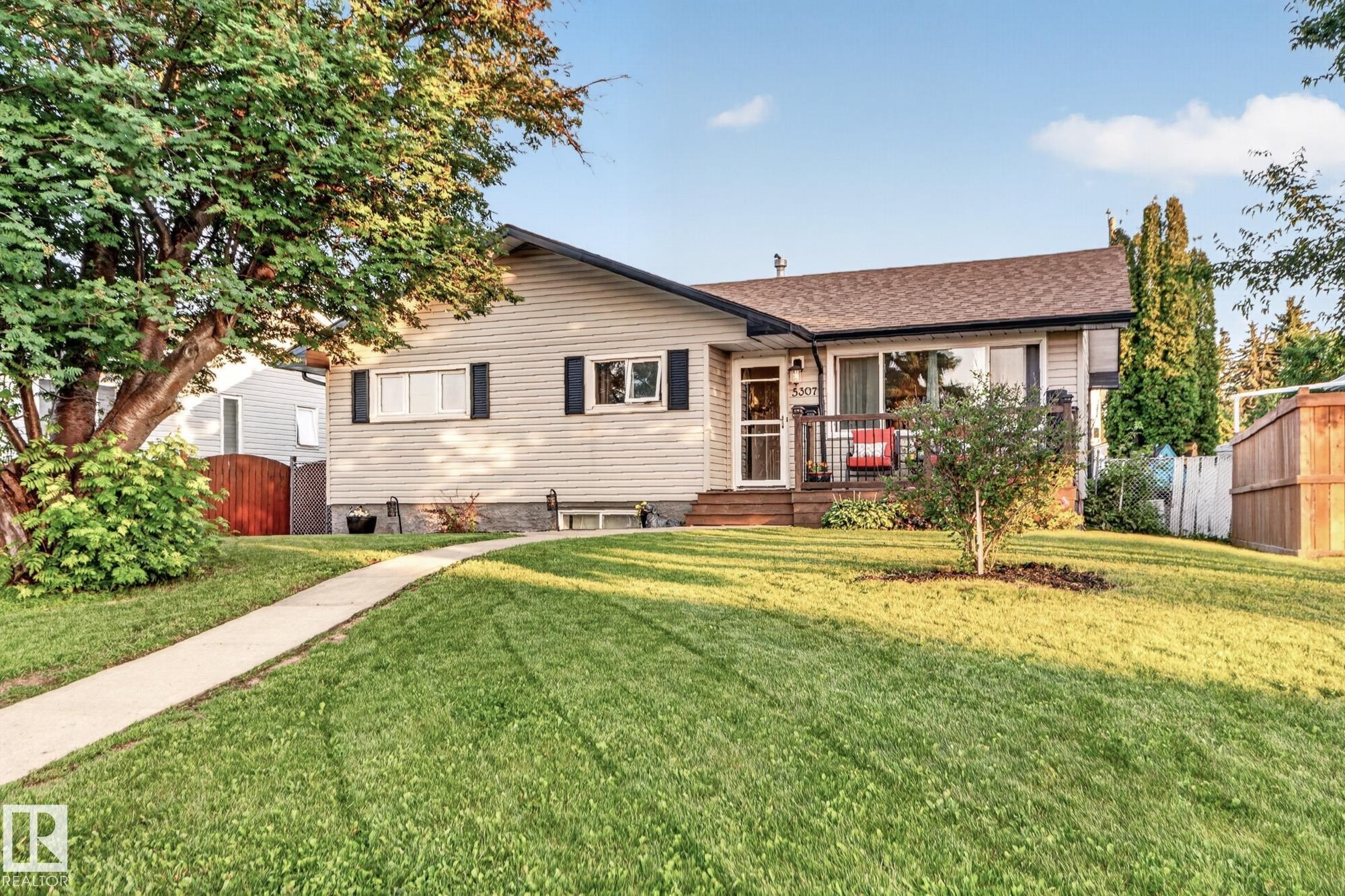 Exterior featuring light-colored siding, dark shutters, and a brown shingle roof - 5307 104 Avenue Nw, Edmonton, AB - Outdoor