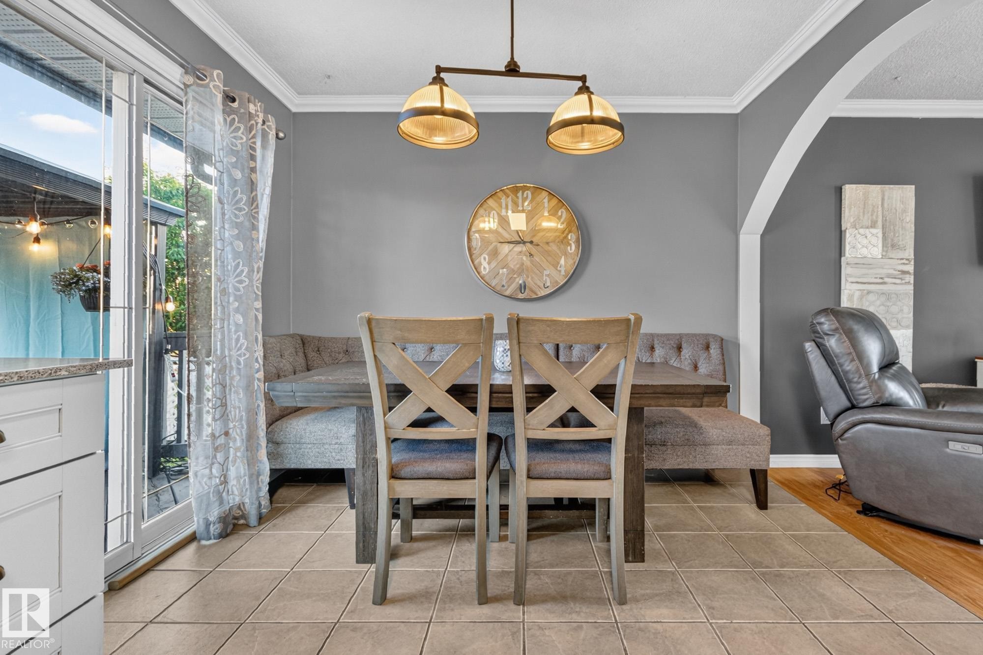 Dining area with tile flooring and a built-in bench seating arrangement - 5307 104 Avenue Nw, Edmonton, AB - Indoor Photo Showing Dining Room