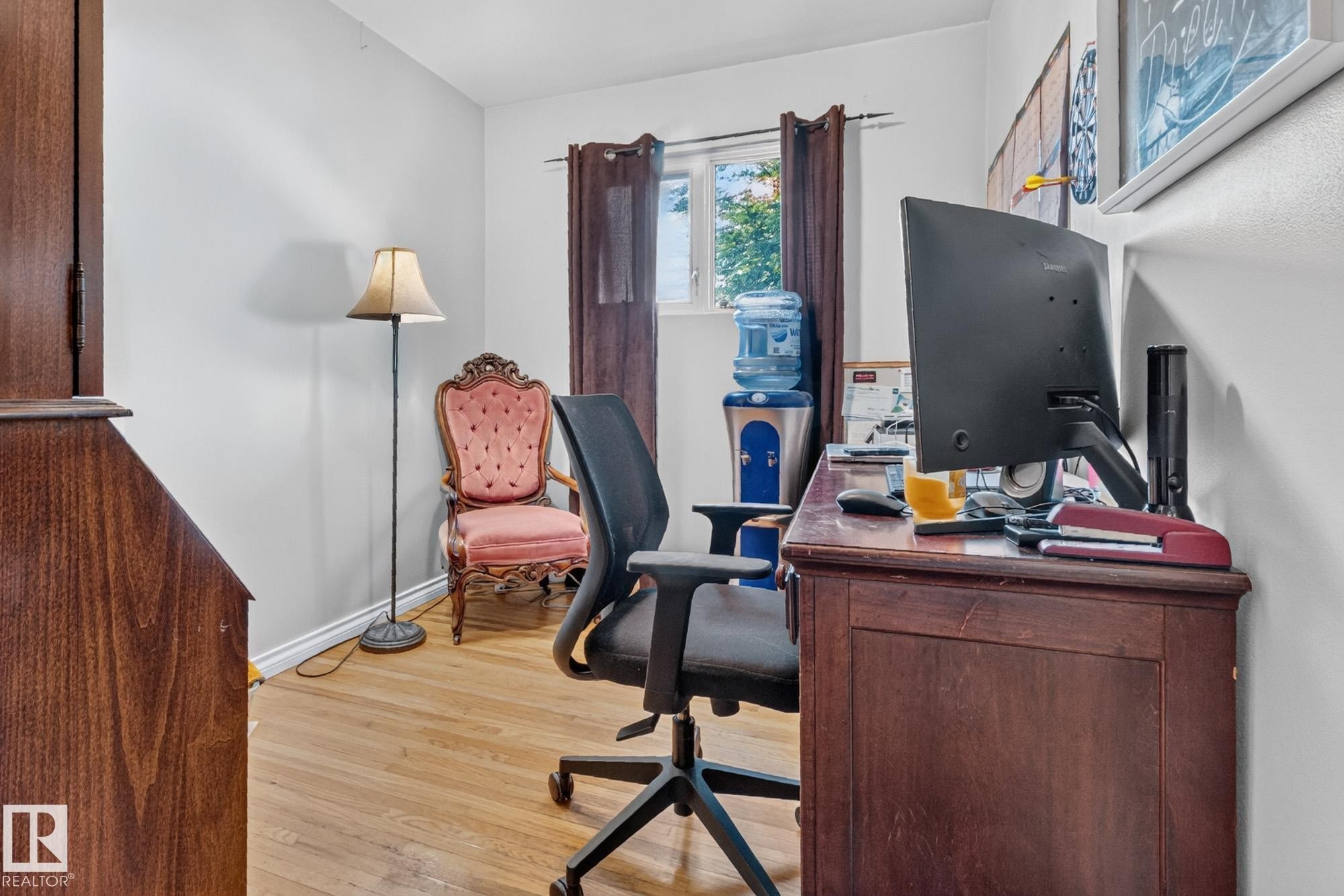 Room featuring wood-finish flooring, white walls, and a window with dark curtains - 5307 104 Avenue Nw, Edmonton, AB - Indoor Photo Showing Office