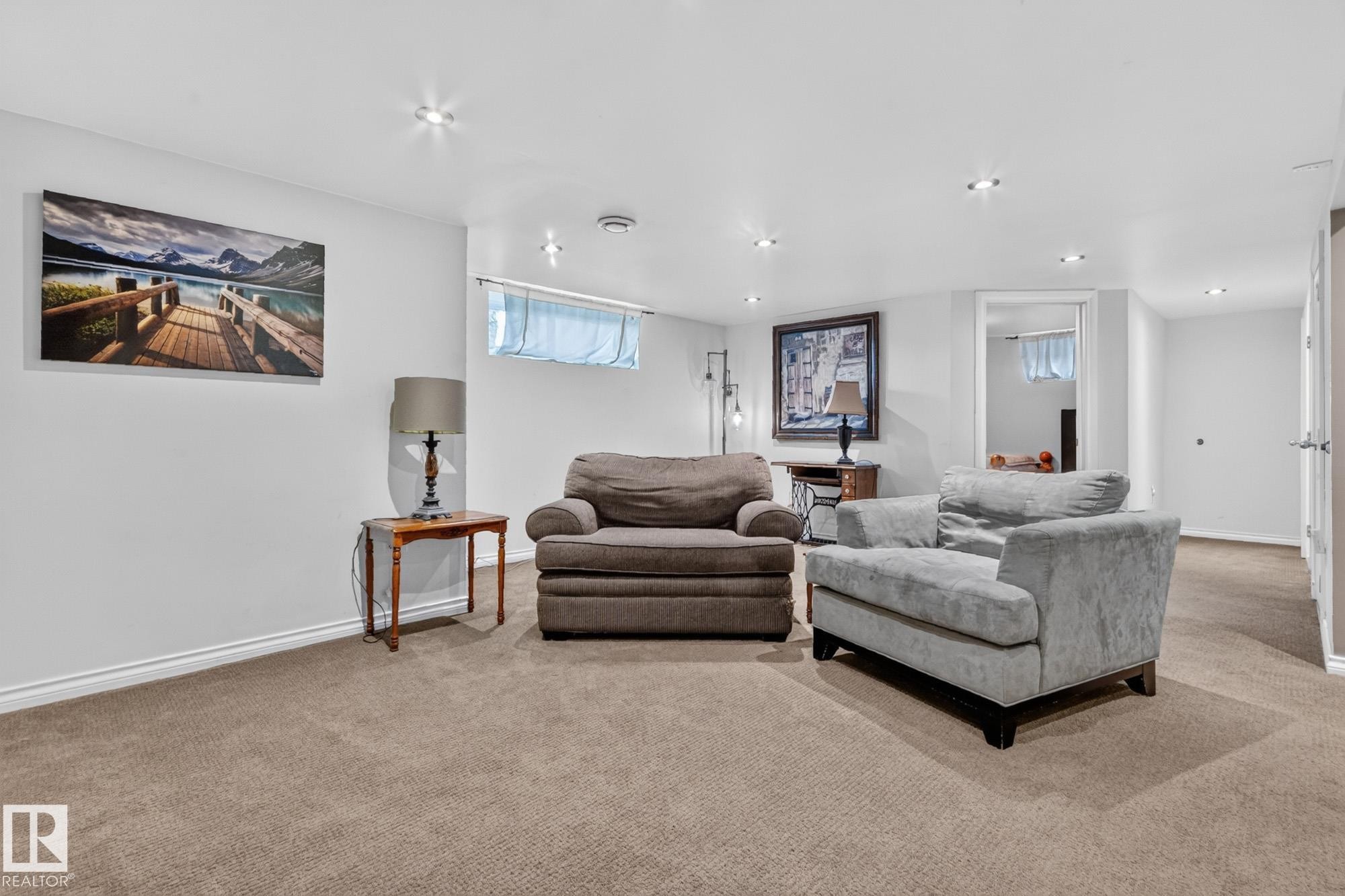 Carpeted lower level room featuring recessed lighting, painted walls, and a visible window - 5307 104 Avenue Nw, Edmonton, AB - Indoor Photo Showing Living Room